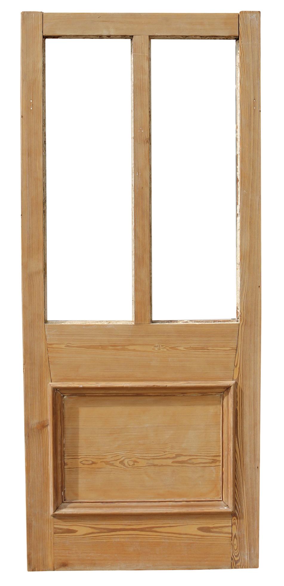 A reclaimed exterior door made from pine, with two spaces for glazing.