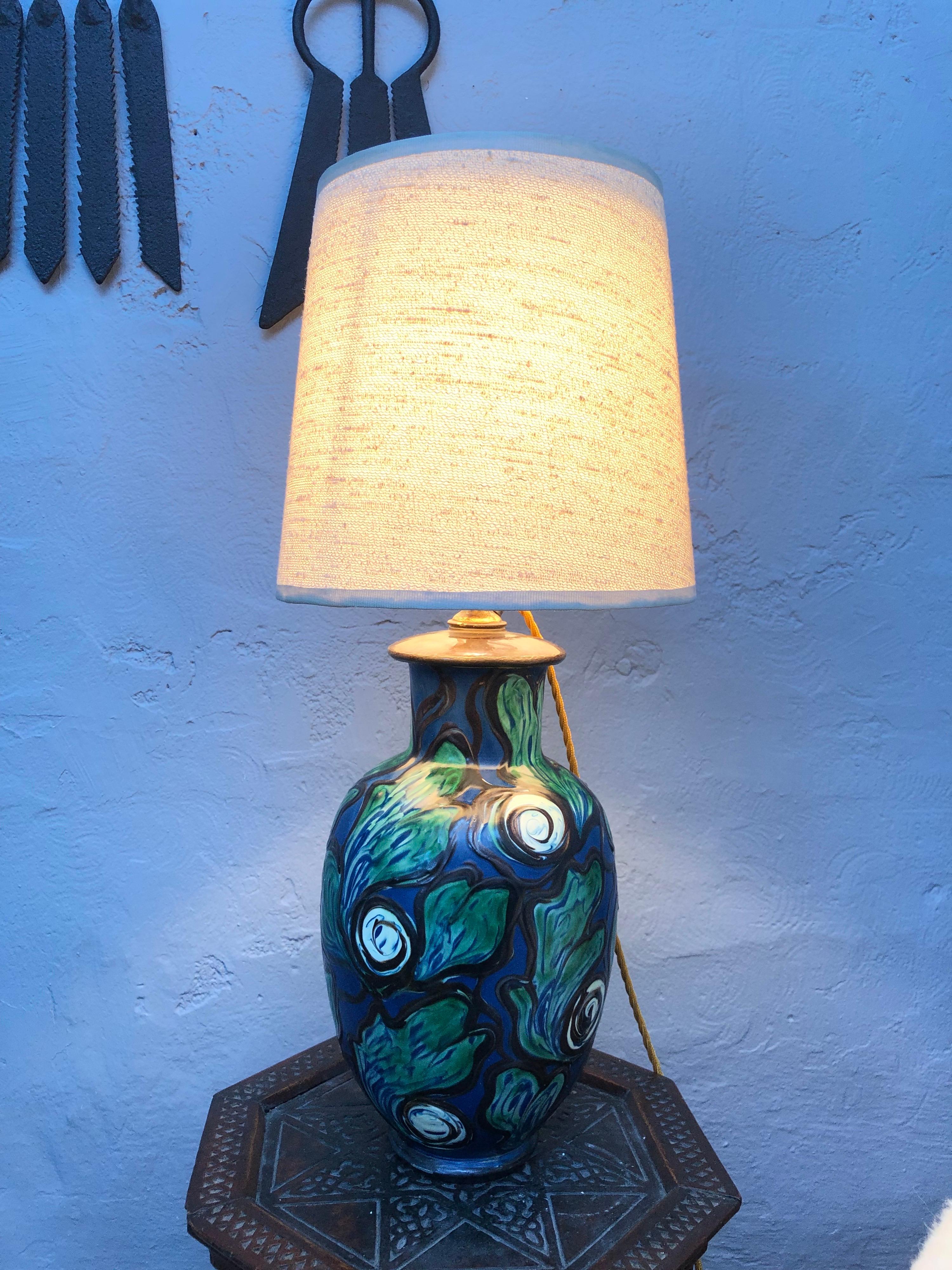A large antique Art Nouveau painted pottery table lamp from the 1910s..
In great condition with no cracks or chips 
Still with all its original lamp parts such as the brass and ceramic bulb holder. 
Rewired with a gold twisted cloth flex and