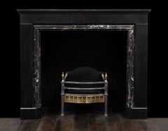 An antique black fossil and Portoro marble fireplace made during the 1830's