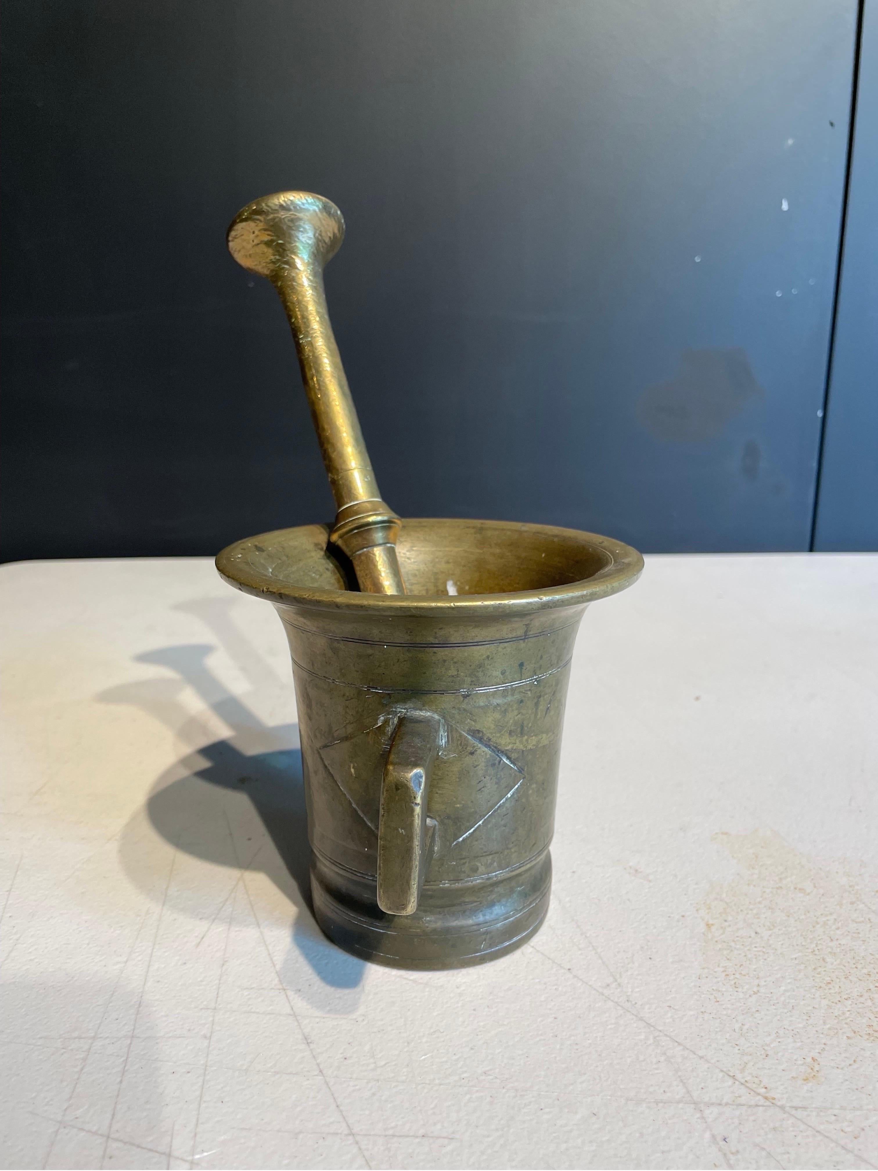An Antique Brass Mortar with Pestle, 19th Century

Dimension: Mortar: Height: 11.5 cm Diameter: 14 cm. Pestle: Height: 24 cm Diameter: 4 cm.

Provenance: Private Sydney Collection.