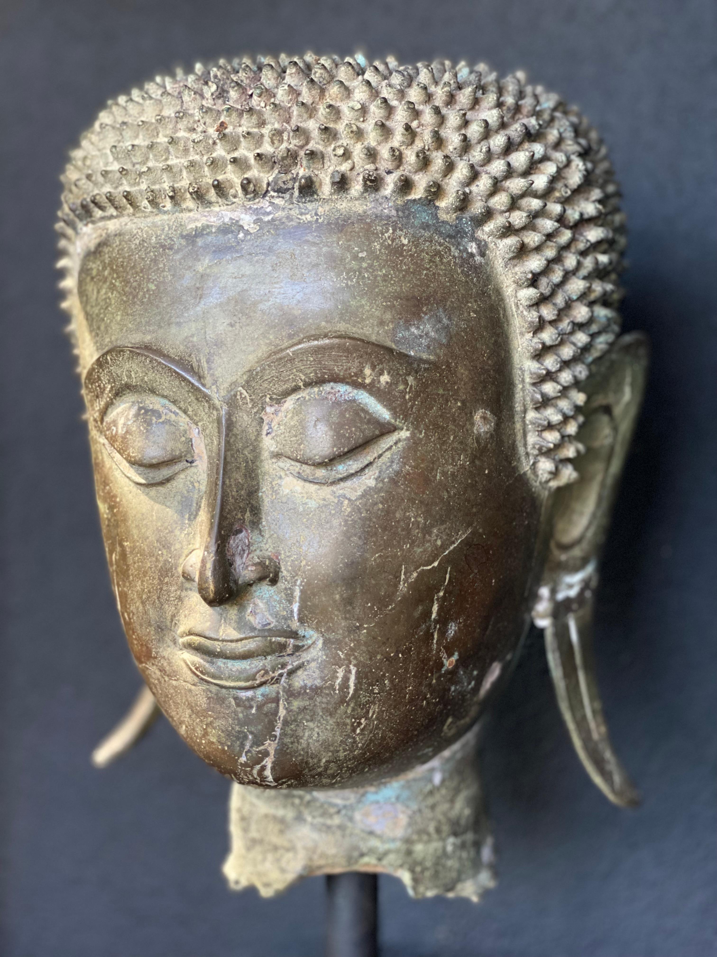 Patinated An antique Bronze Buddha Head