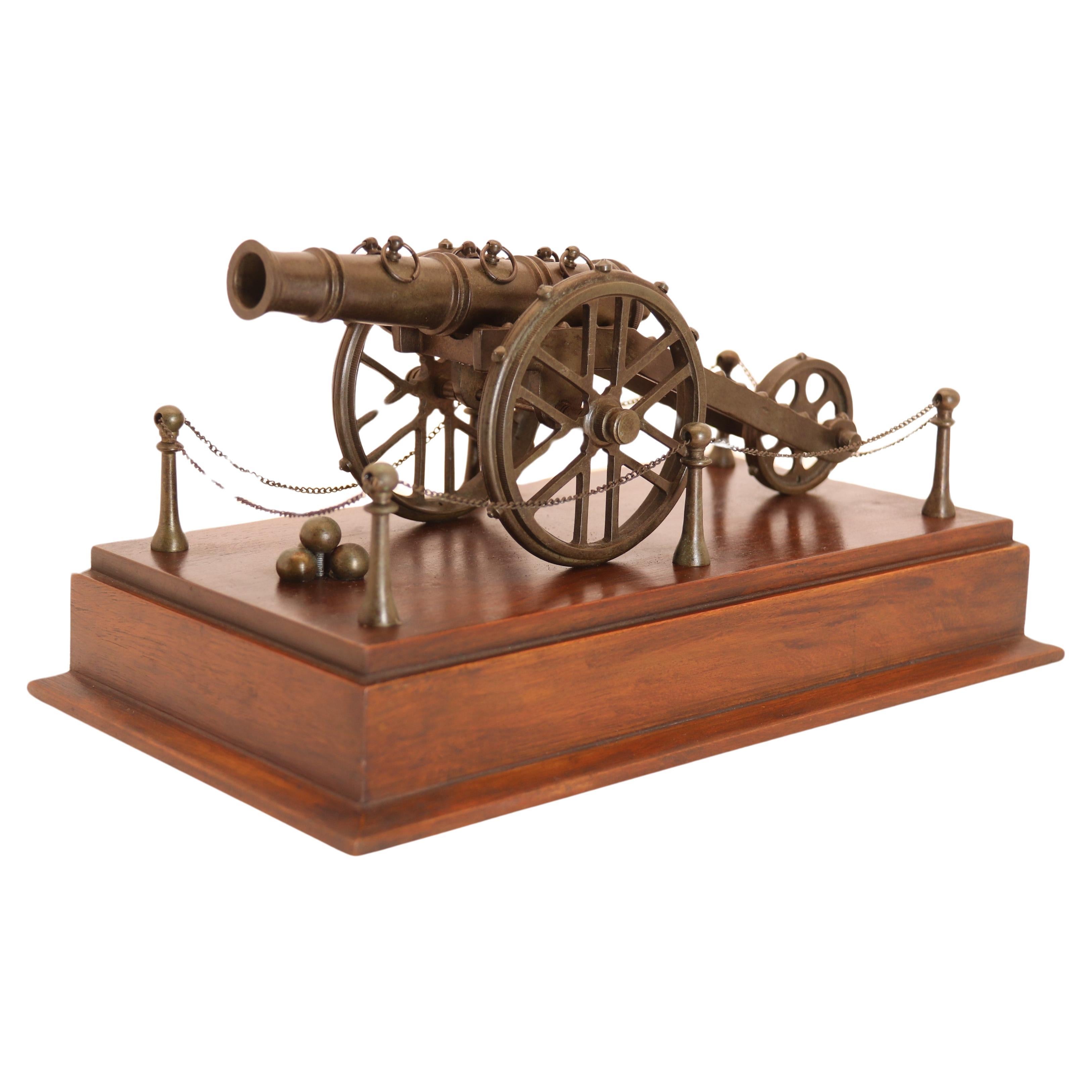 An antique bronze scale model of an 18th century cannon on a hardwood base c1920 For Sale