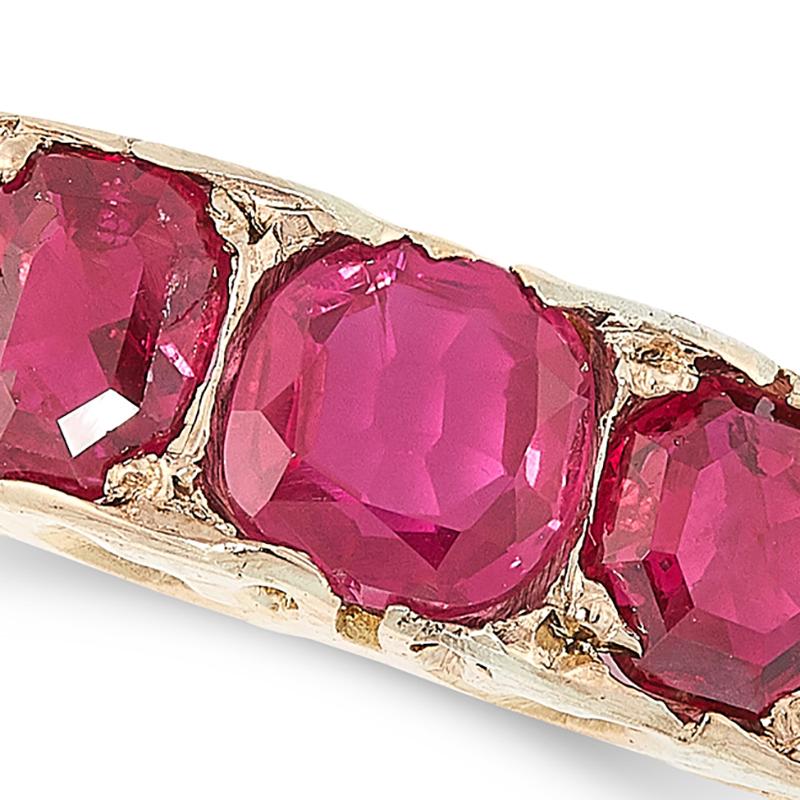An antique Burma ruby dress ring, set with five graduated cushion cut rubies totalling 1.52 carats, within a scrolling shank, marked indistinctly, size N / 7. Accompanied by a gemological report stating that the rubies are of Burmese (Myanmar)