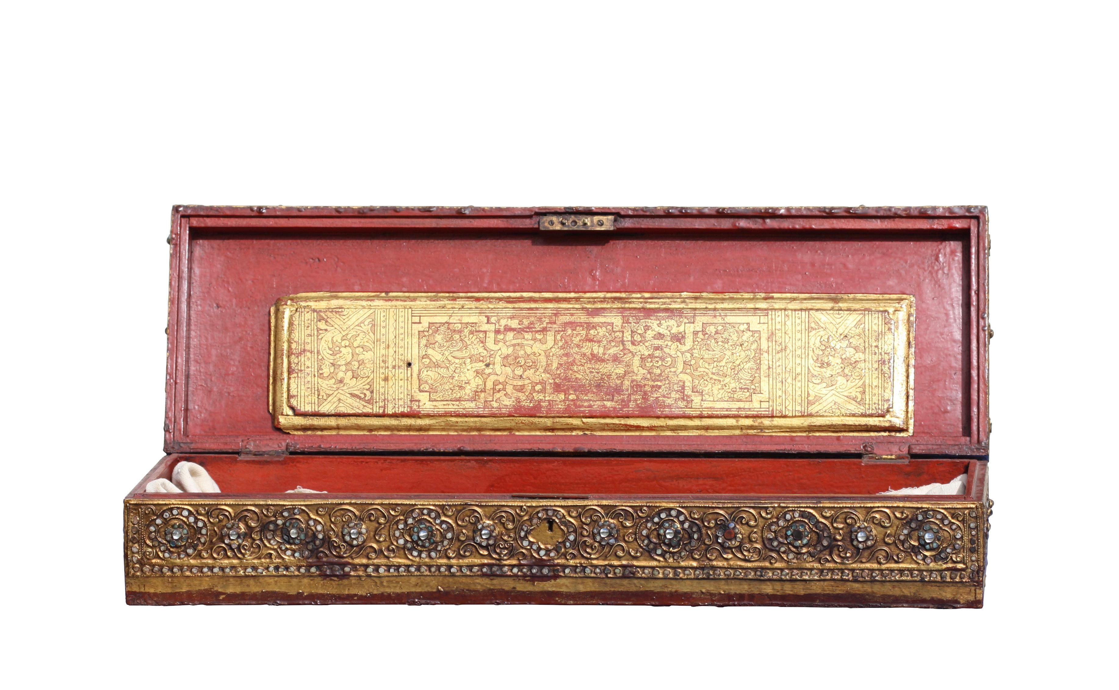 An antique Burmese set of sixteen double-sided Kammavaca or Buddhist manuscripts,
written in Bali in red and black lacquer on a gold leaf ground.
This set is accompanied by the original pair of gold leaf and red lacquer pictorial cover