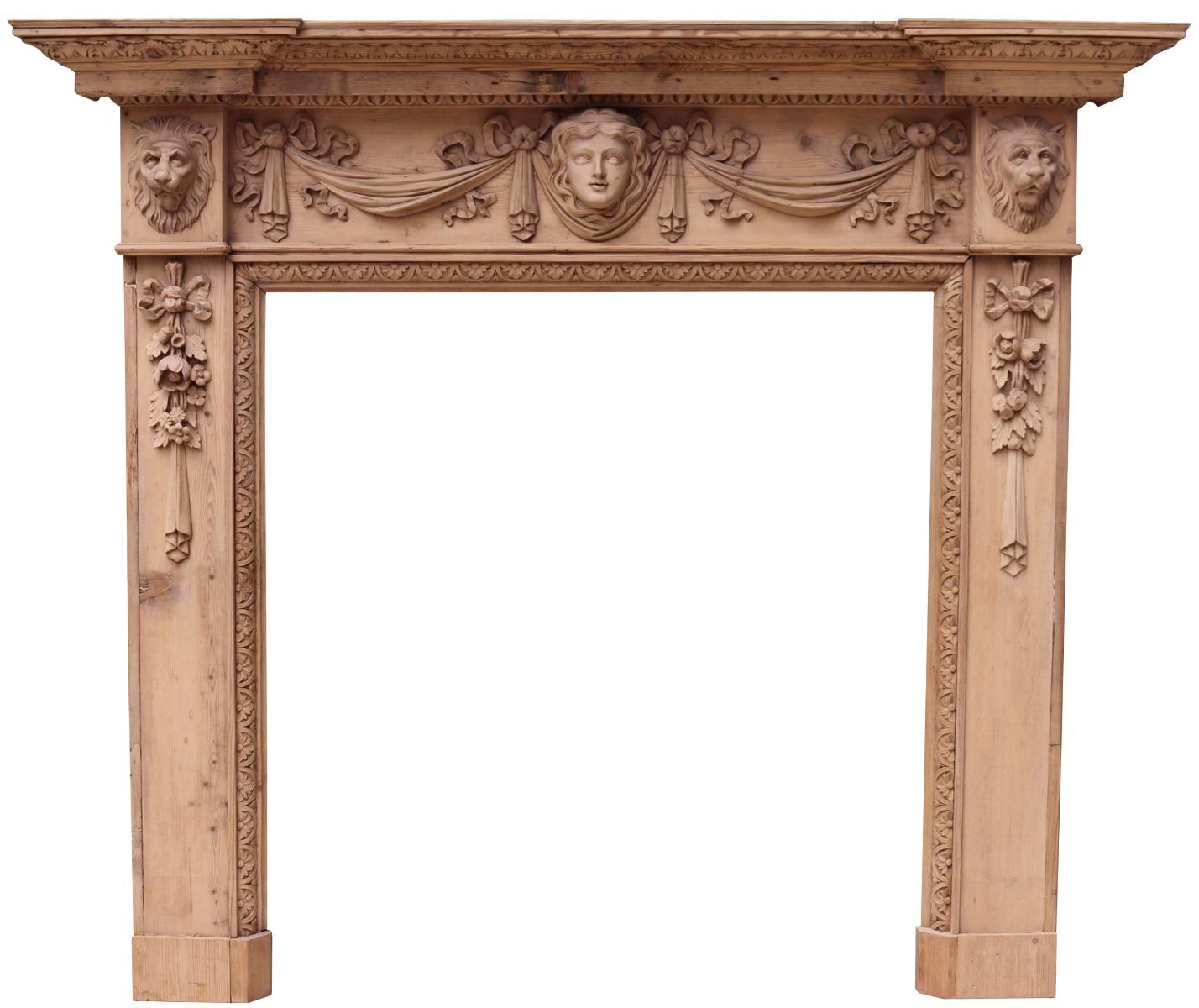 An antique carved pine fire surround in the early Georgian / Palladian style of William Kent. Carved with female mask and drapery to the frieze, lion mask end blocks and drapes to the jambs. Breakfront shelf with egg and dart