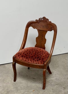 An antique carved Victorian wood bergère chair with peacock upholstery, c. 1900