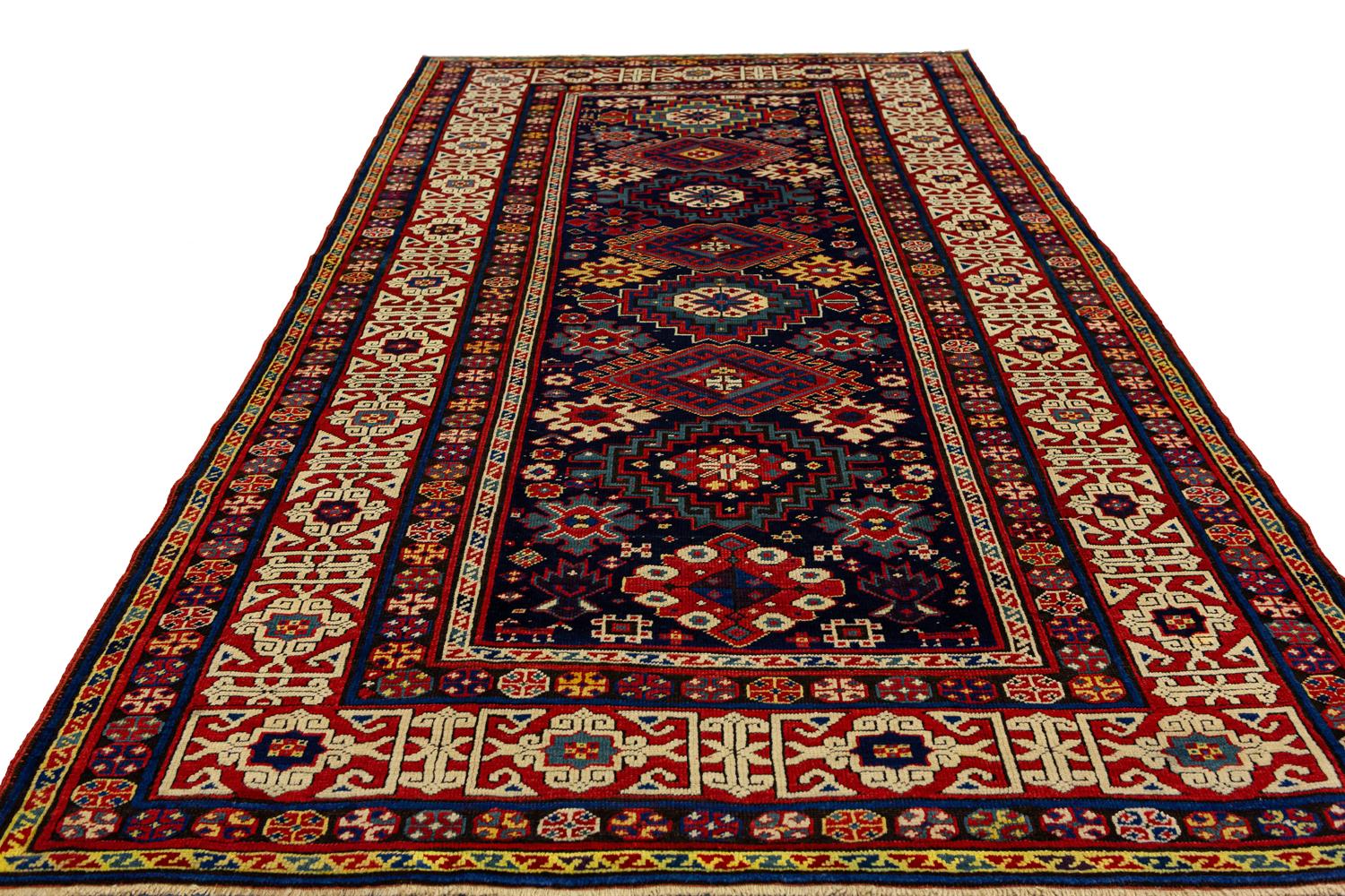 This Antique Caucasian Kuba Rug is a must have for any antique collector or lover of beautiful things! The bold design and rich colors make it a statement piece that will be admired by all who see it. It would add a touch of elegance to any room,