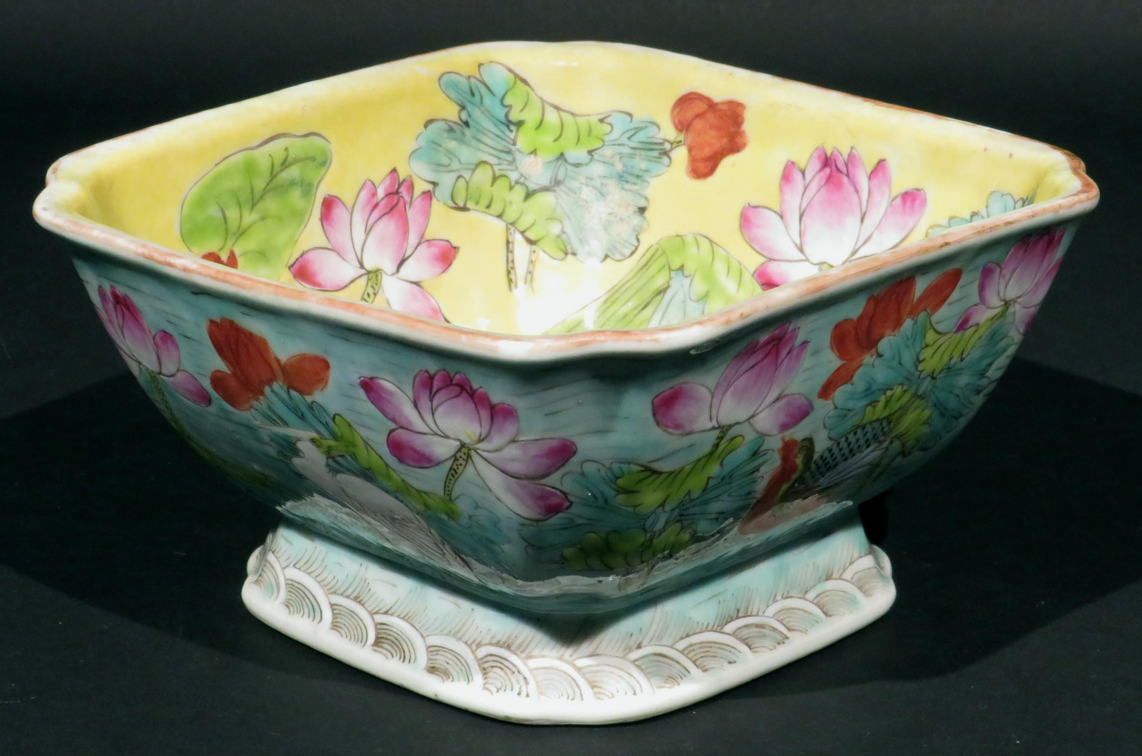 A very attractive Chinese export enamelled porcelain bowl, having a squared body with inverted corners and traces or red oxide along the rim, decorated on the interior with hand painted enamels of flower blossoms & waterfowl against a yellow field,