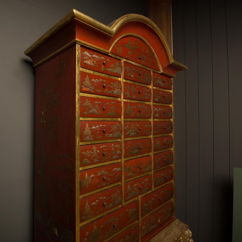 An antique chinoiserie lacquer storage cabinet with 26 drawers on carved giltwood stand.