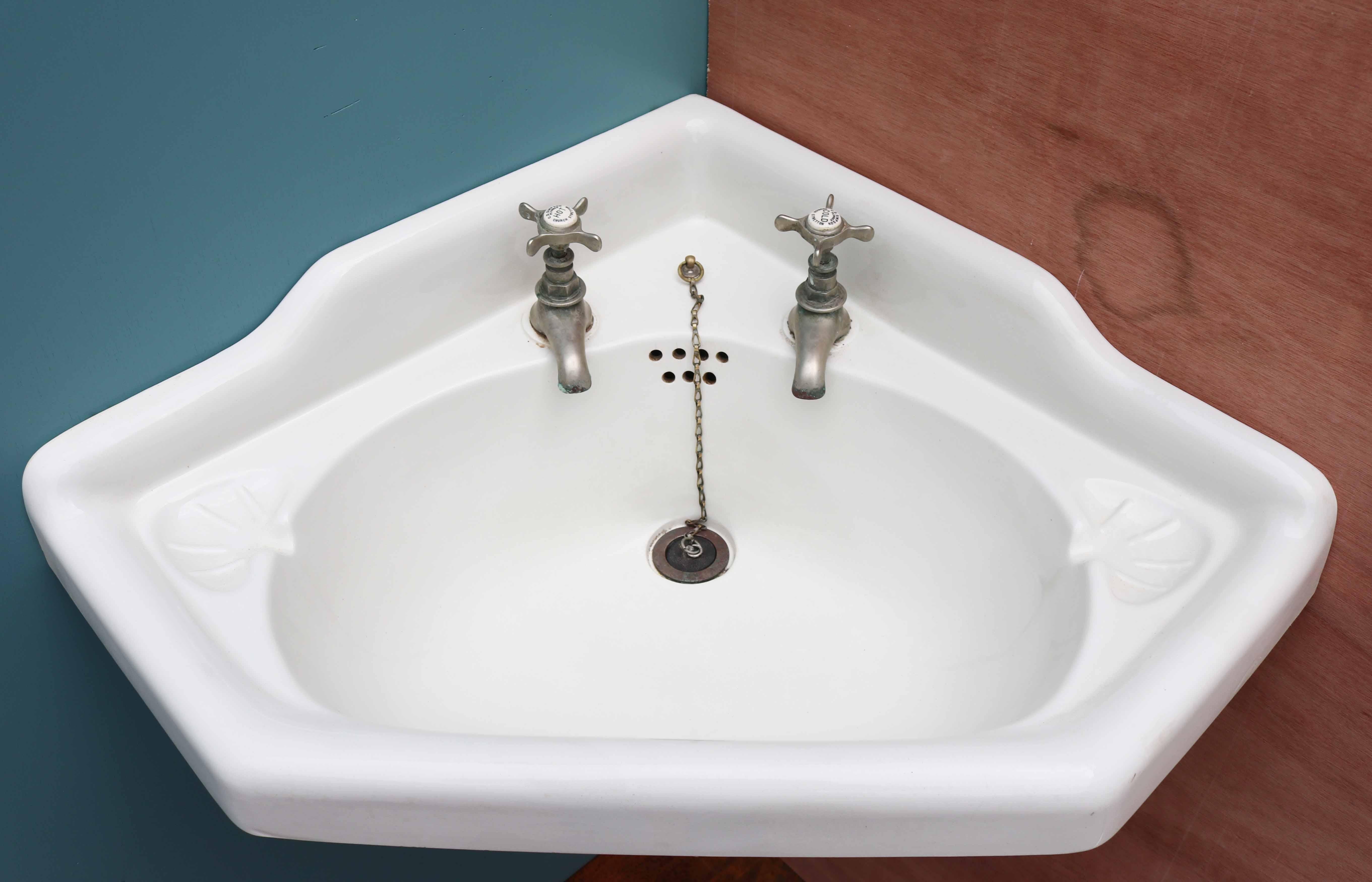 A reclaimed porcelain corner basin with original wall mounted bracket, finished in grey primer. The taps are marked ‘C Simpson Plumber Church Stretton’.

Additional dimensions:

Width 56cm x 56cm each side.