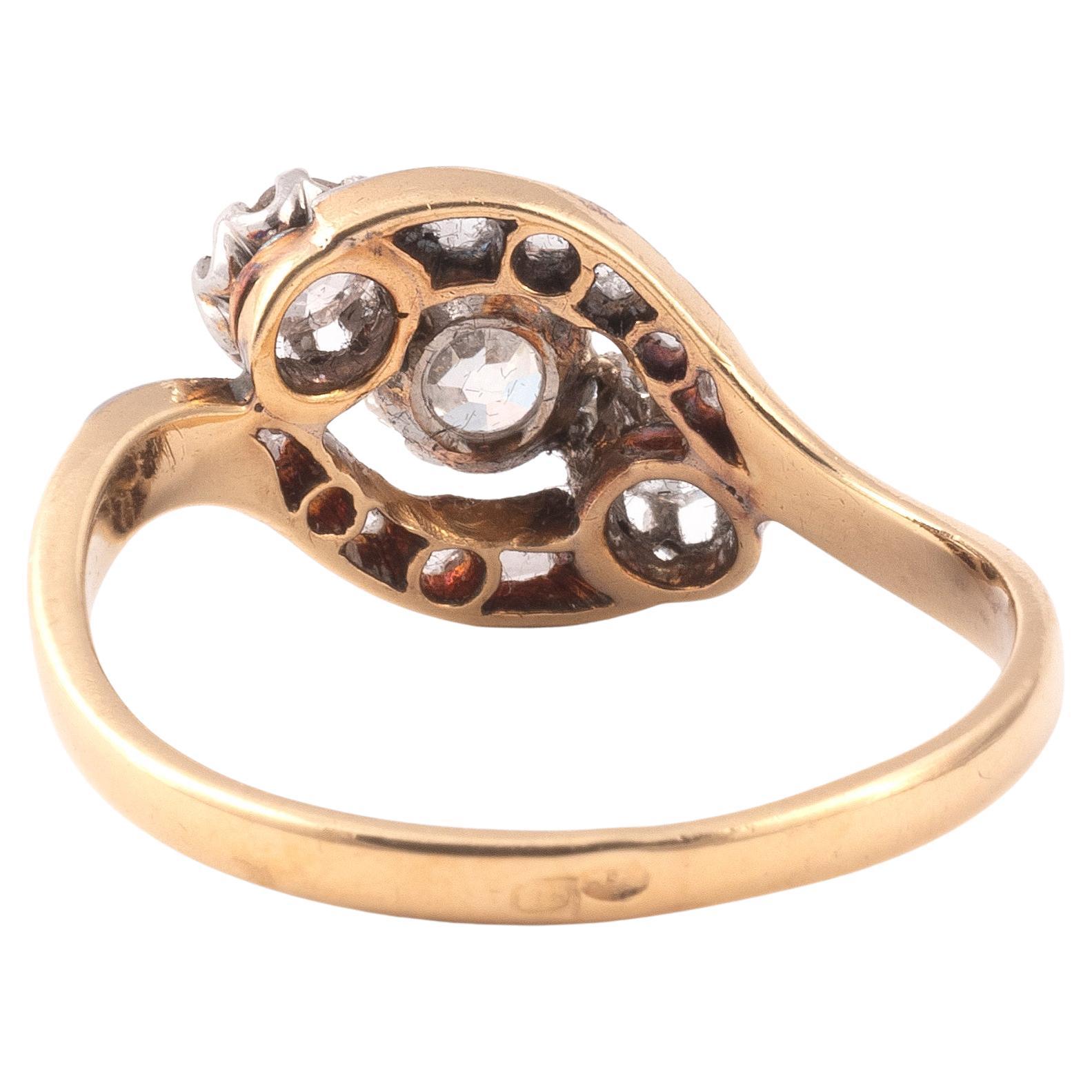 Anello incrociato in oro giallo 18K e argento con tre diamanti taglio old mine di circa 0,50 carati,  sottolineato da due linee di diamanti taglio rosa.
Dimensione: 7 
Peso: 3gr.



