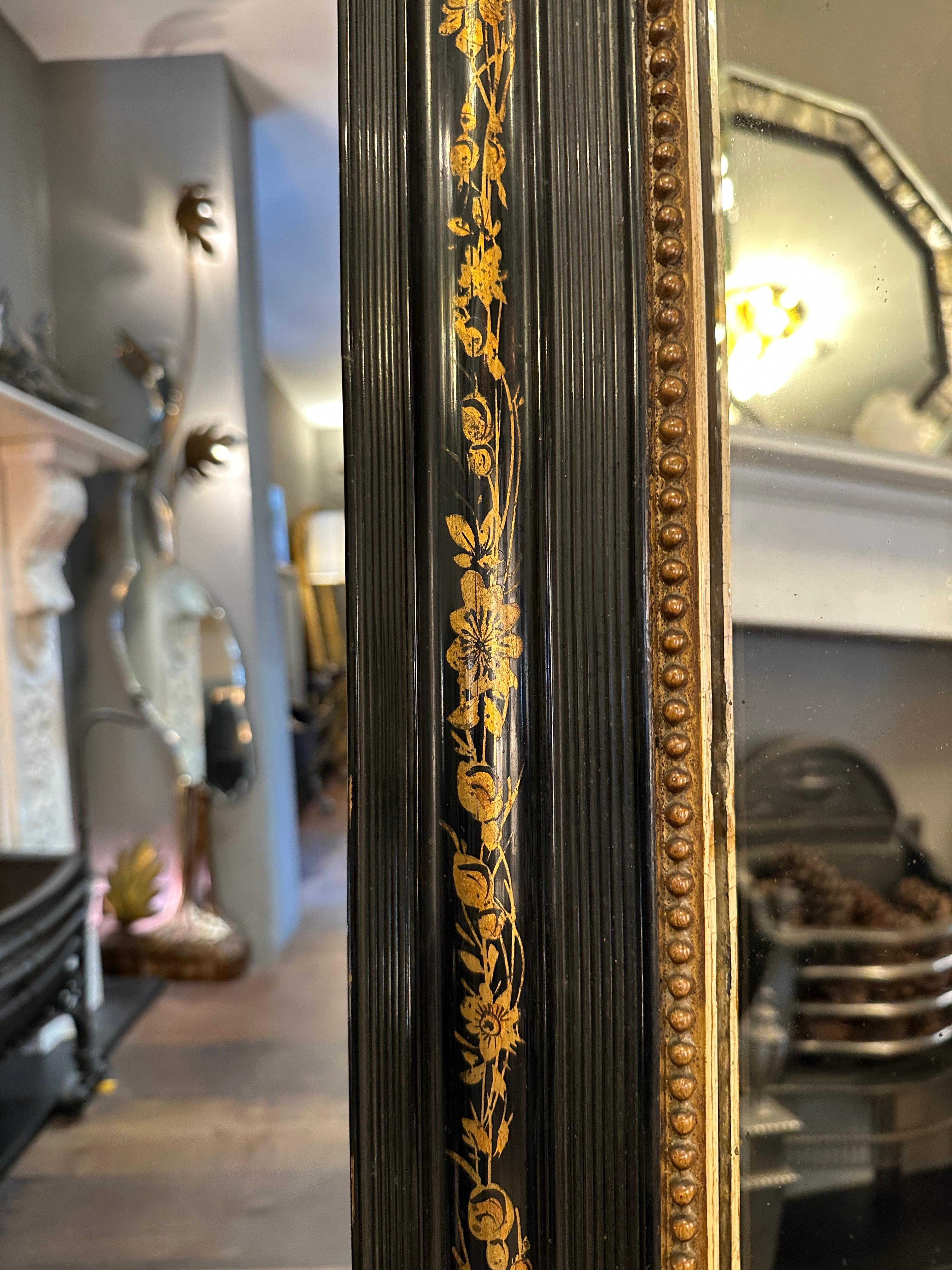 A domed topped art Nouveau period ebonised and gilt with floral transferred design mirror circa 1890. The gold gilt beaded inner edge framed by a wide reeded slip and wonder floral design within the frame. Original backboards and glass plate. 