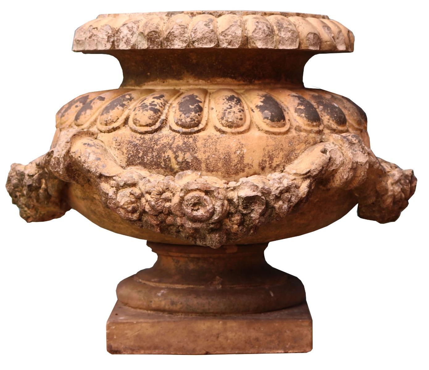 A Doulton terracotta garden urn, decorated with applied floral garlands. Makers stamp inside the bowl.

Additional dimensions:

Width base 21.5 x 21.5 cm

Diameter maximum 45 cm

Internal diameter 17  cm.