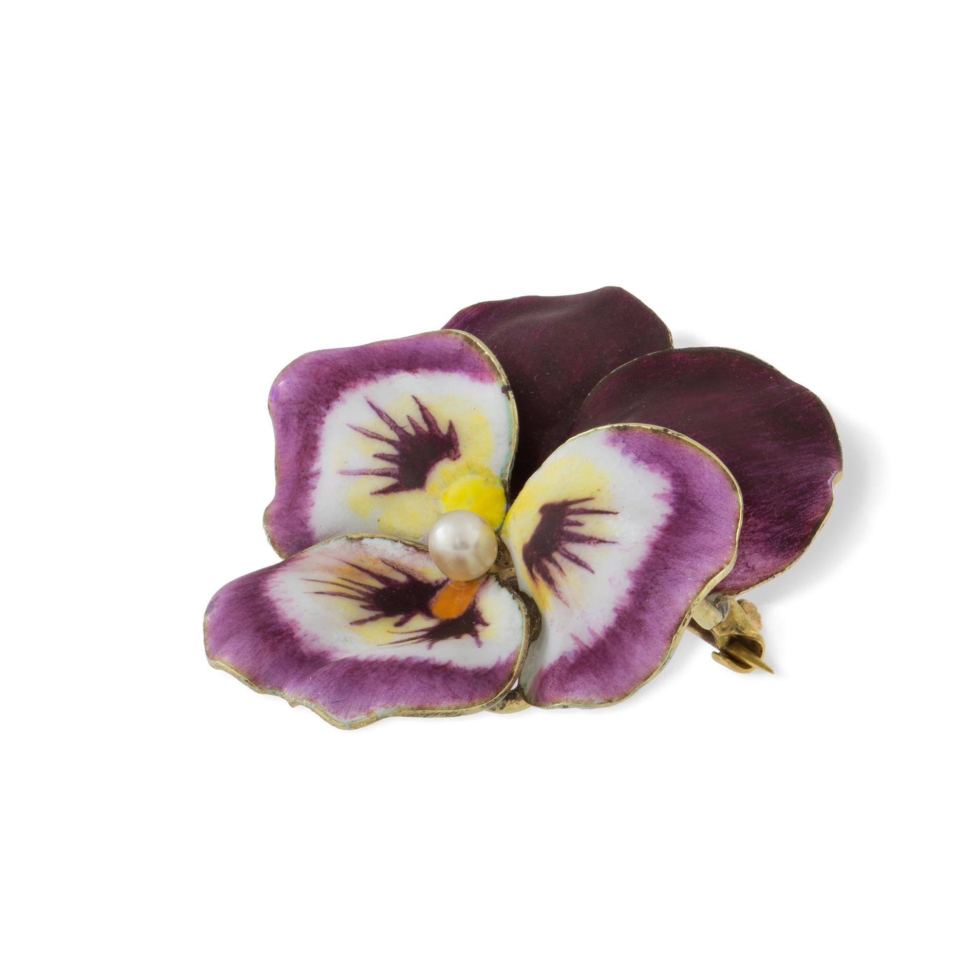 An antique enamel and pearl pansy brooch, the round pearl measuring approximately 3mm set to the centre of five realistically carved and enamelled petals with a yellow gold back with brooch fittings,  circa 1900, made by A.J Hedges & Co in the USA,