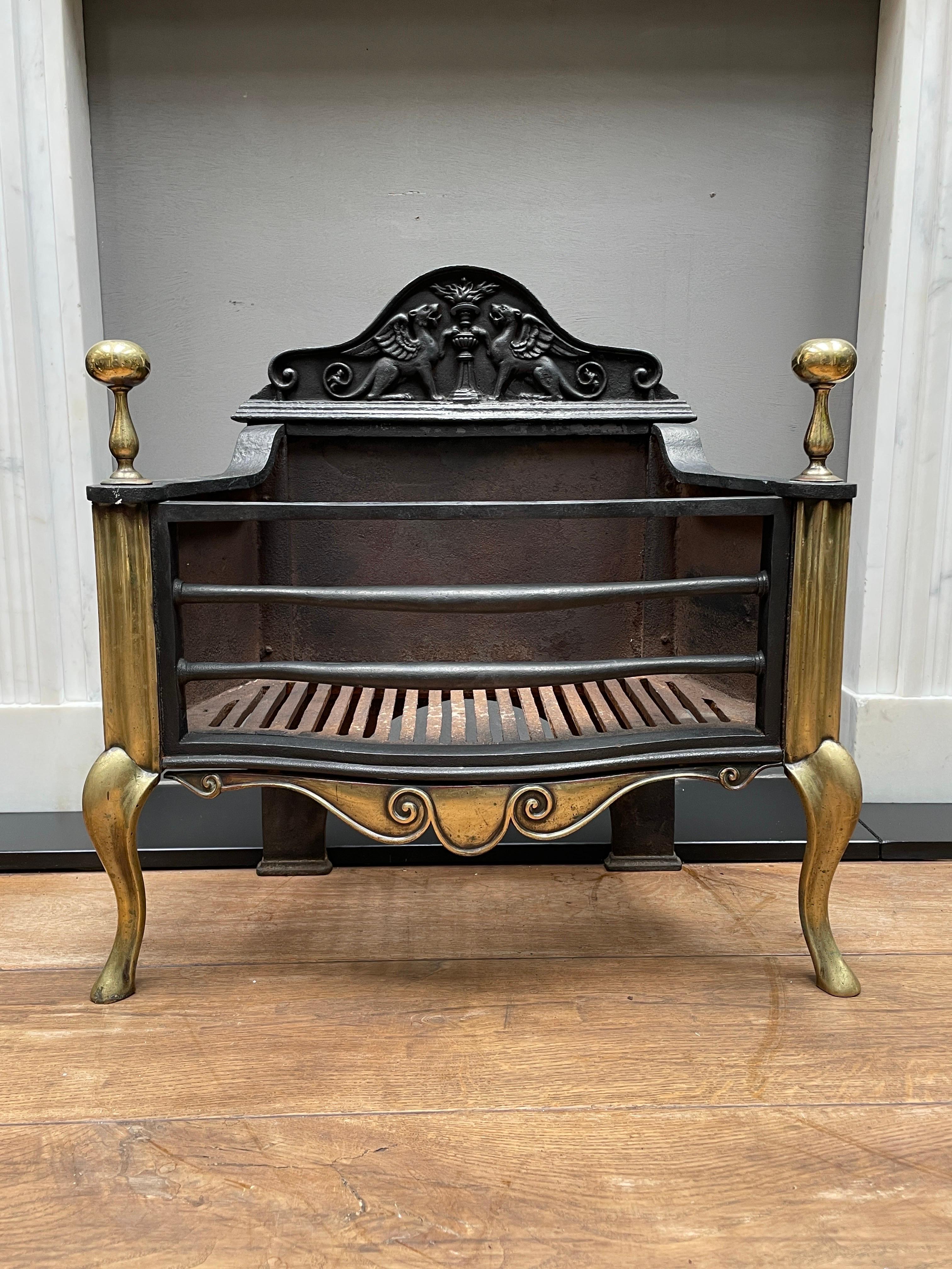A Queen Anne style fire grate by renowned Foundry Thomas Elsley, circa 1860.
A very good quality grate in brass and cast iron. The cabriole legs, bulbas finials and scrolled apron in brass. The decorative fire back with opposing Griffins. 
Stamped