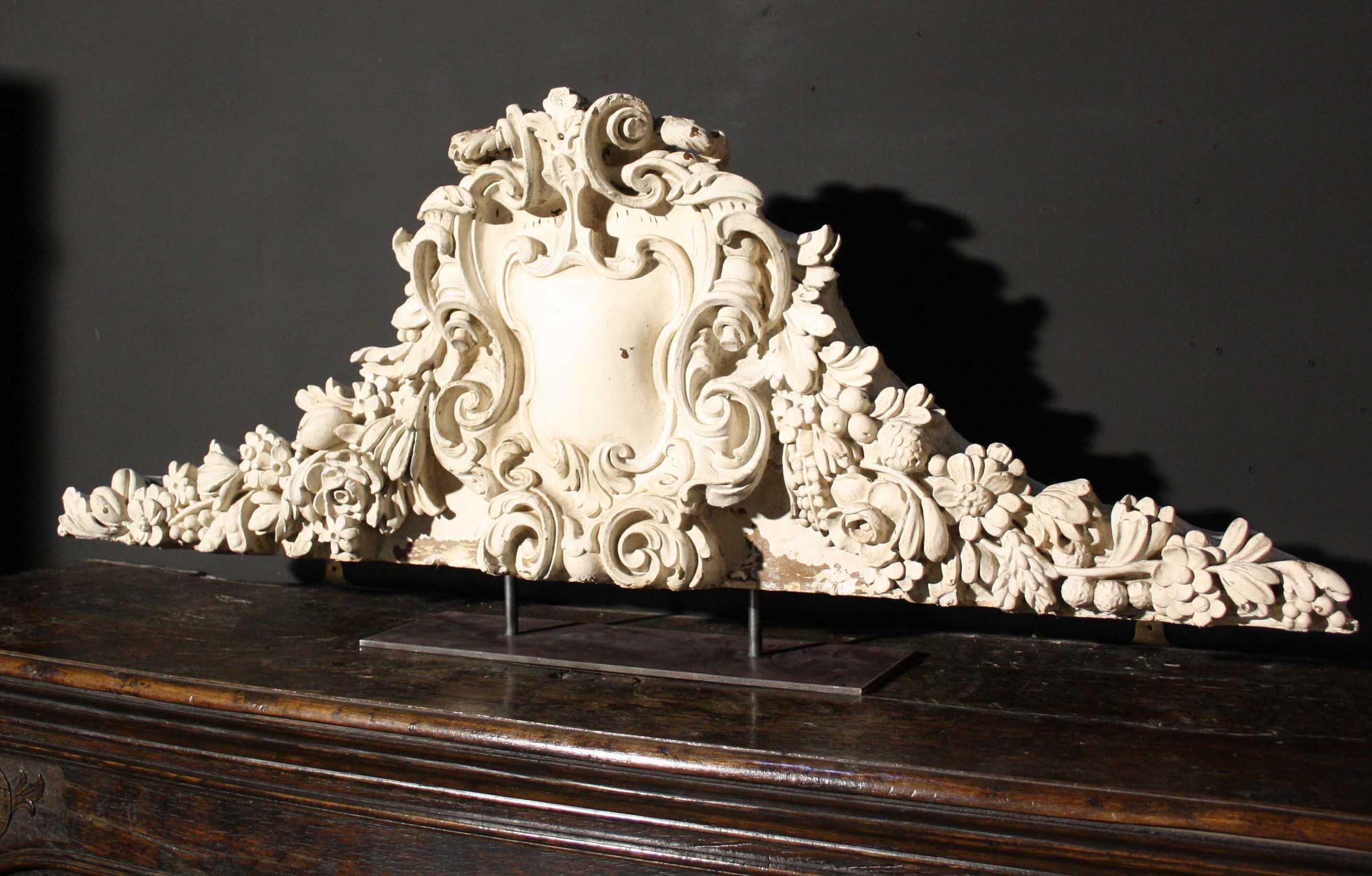 A decorative reclaimed plaster pediment mounted on a steel stand.

Condition report

Good structural condition. Mounted to a later steel stand.

Style

Georgian, Neoclassical, Rococo and Victorian

Date of manufacture

circa