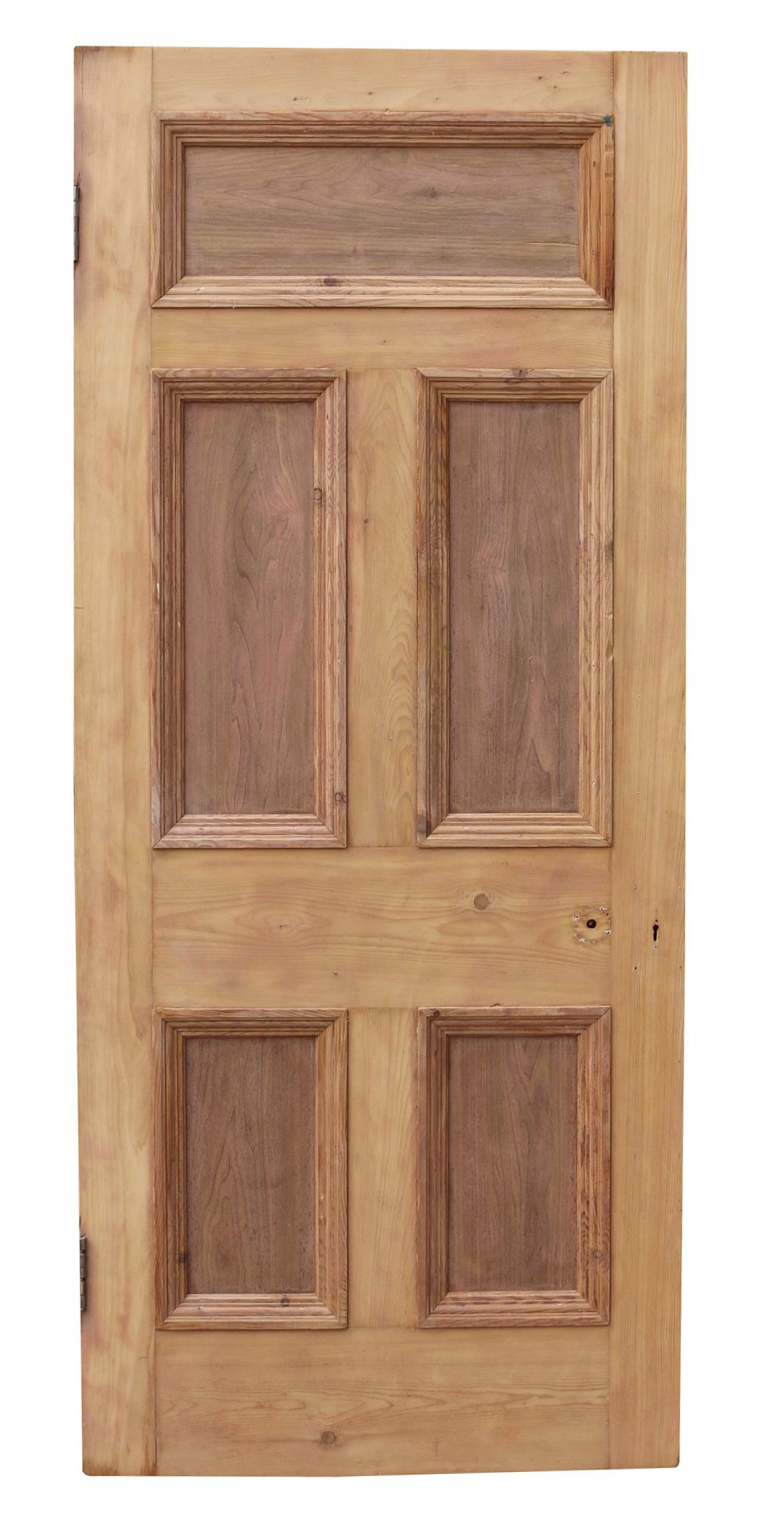 A reclaimed door constructed from pine to a five panel design.