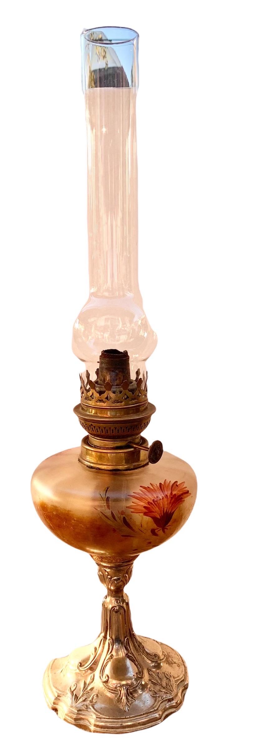 An exquisite antique French Art Nouveau oil lamp having a stunning hand painted and frosted oil font and a later quality hand blown glass chimney. The hand painted flowers are whimsical and lovely, the silvered metal base organic with scalloped