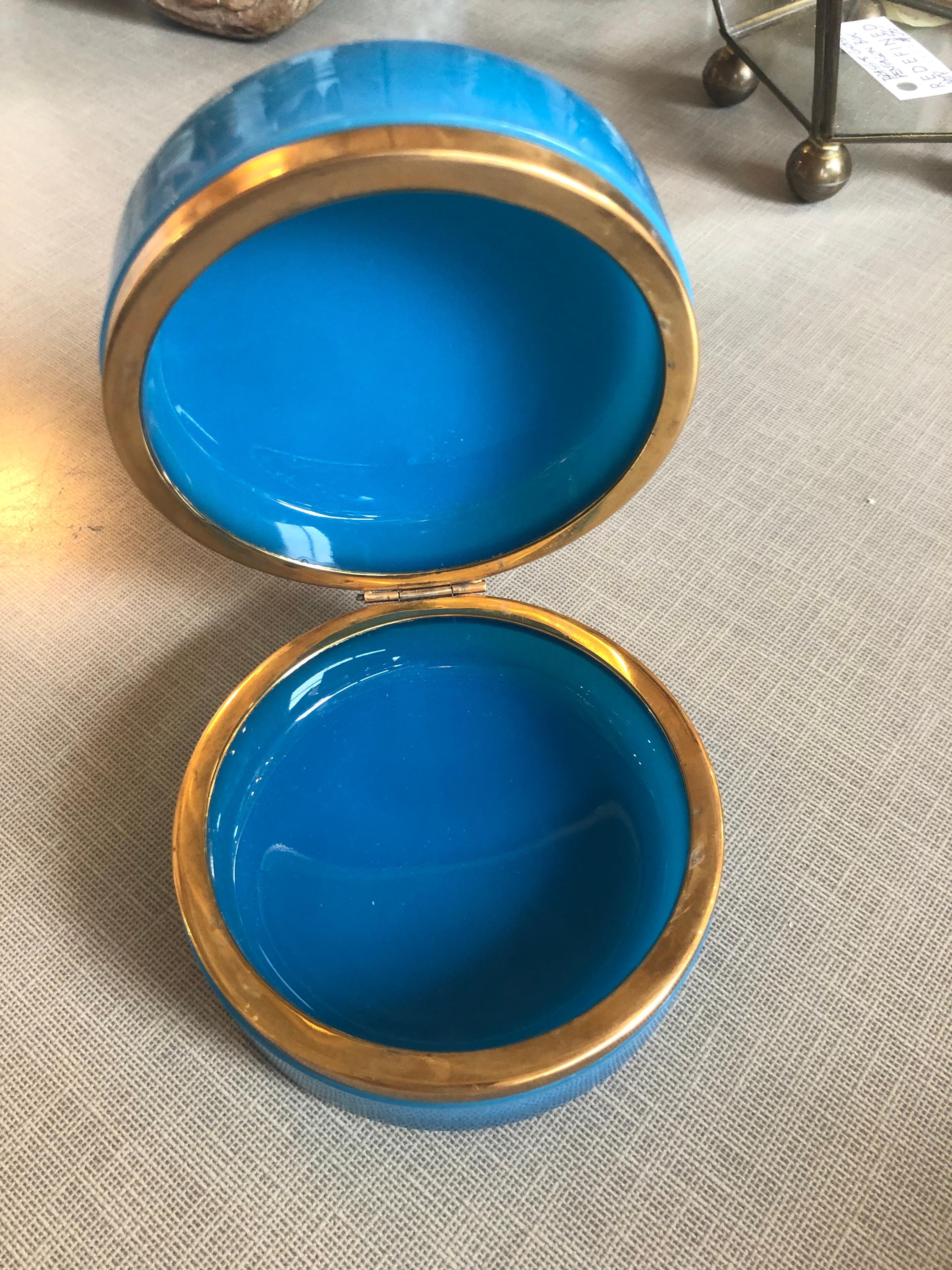 An antique French blue round opaline glass casket or box having a hinged doré bronze banding.
