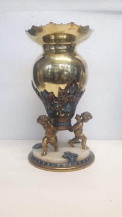 An antique French champlevé enamelled vase with a polished gilt metal body