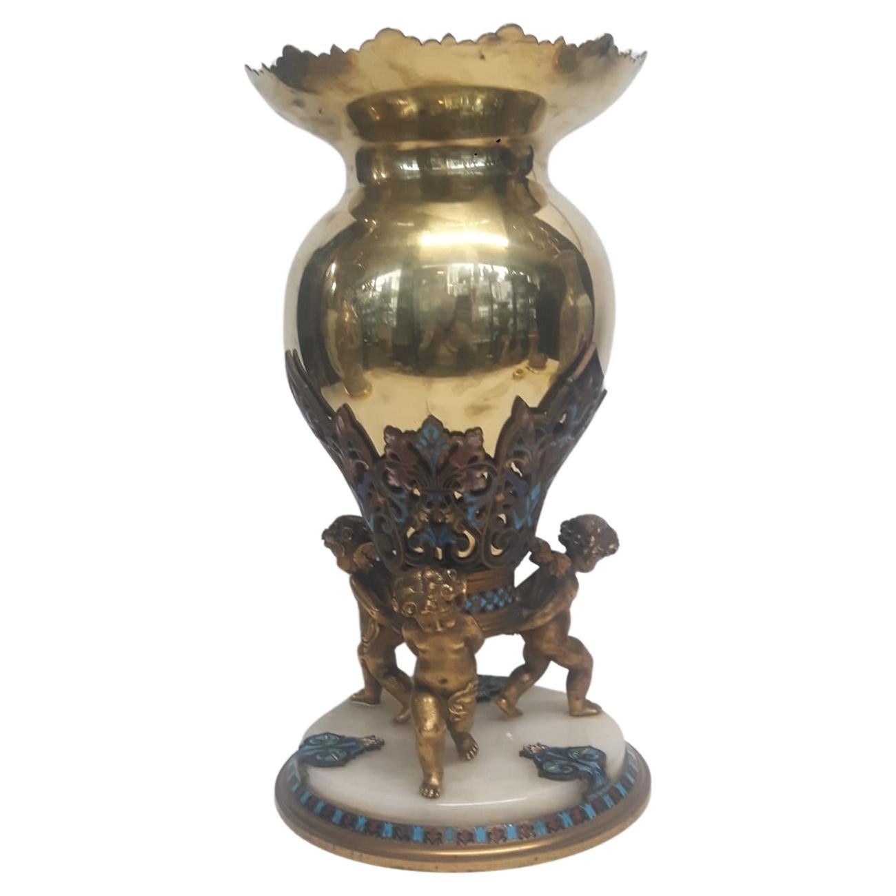 An antique French champlevé enamelled vase with a polished gilt metal body 