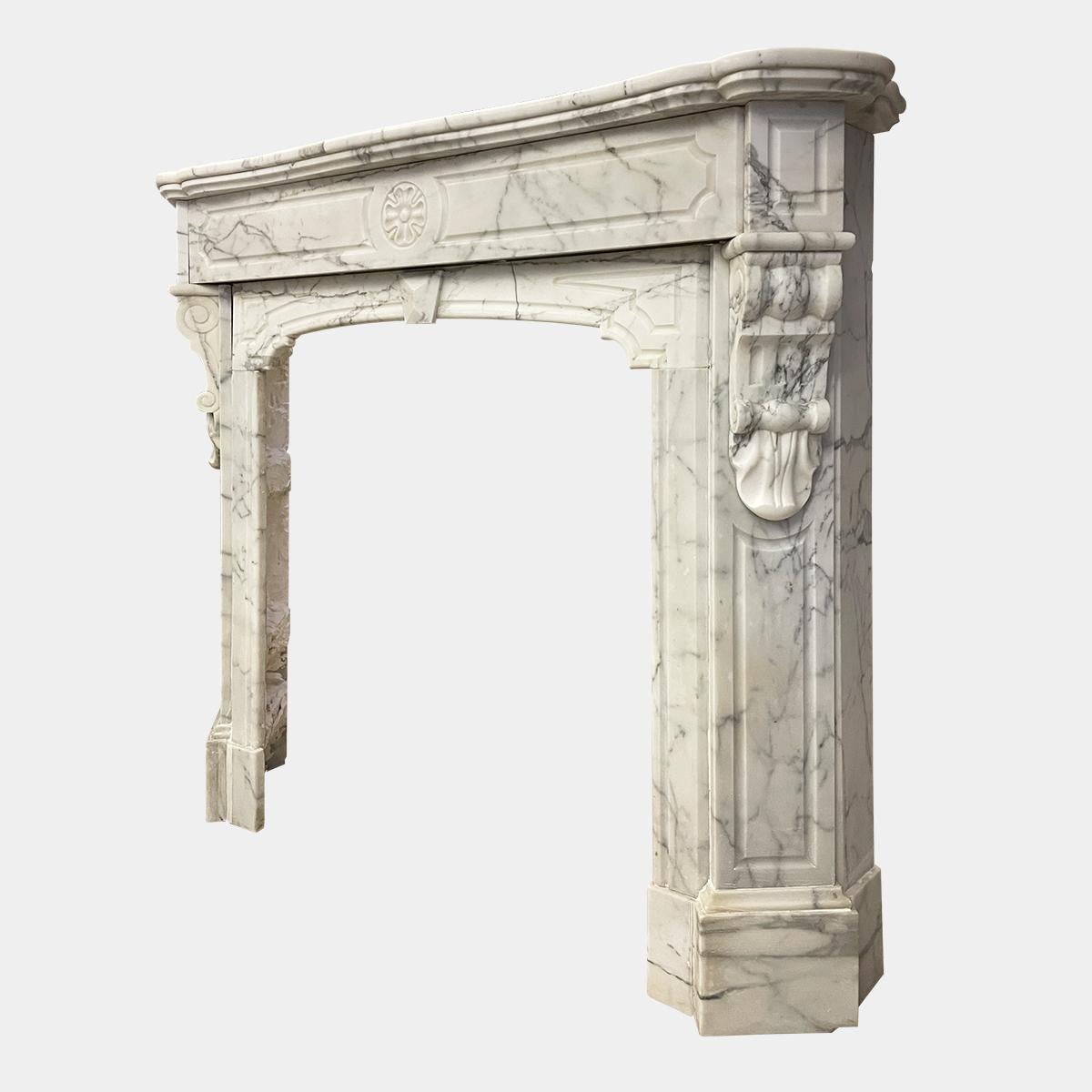 A late 19th c French fireplace in Arabescato marble, a serpentine shelf with panelled frieze below, the centre with carved floral motif. The cantered Jambs with corbeled brackets and panelled end blocks. The interior with a shaped arch 

Opening