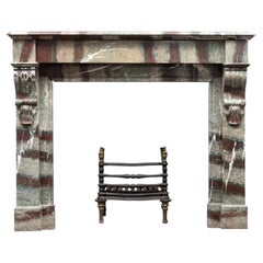 An antique French fireplace surround made from ‘Campan Grand Melange’ marble.