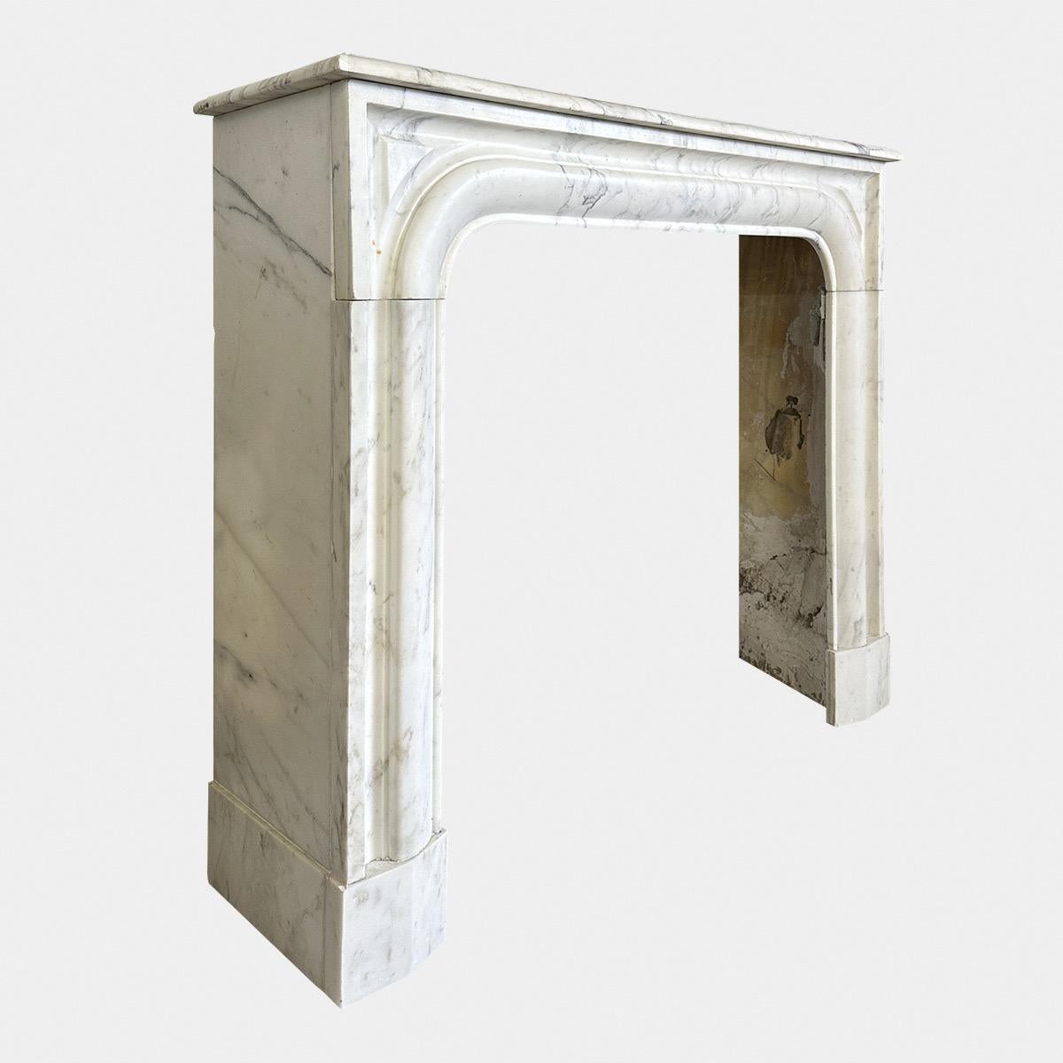 A French mid to late 19th c Louis XIV style Arabescato marble fireplace. Compact in size yet good scale and form in a very pale Italian Arabescato marble. Original depth on shelf and side returns, without breaks or repairs. Gentle moulded frame,