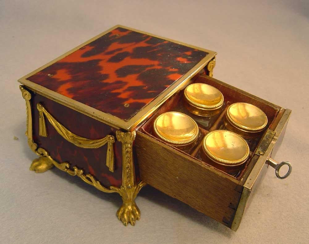 A lovely little antique French Louis XV casket of scarlet tortoiseshell with superb ormolu mounts. Set on ormolu paw feet and with a profusion of ormolu mounts this lovely little box retains its original lock and key. Containing four glass jars with