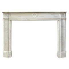 An Antique French Statuary White Marble Louis XVI Style Fireplace mantel