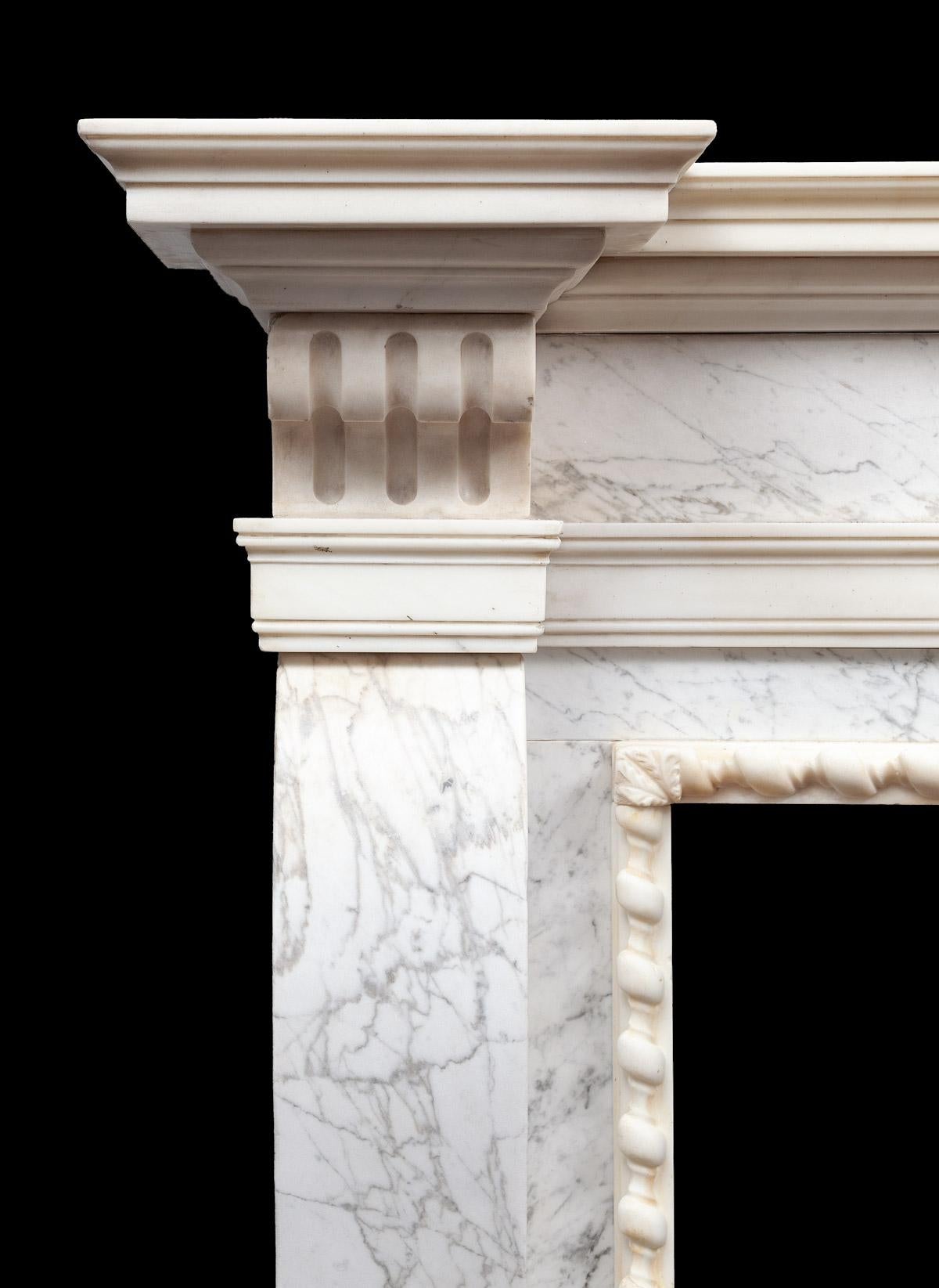 Made from veined Carrara marble and white statuary marble.

The centre plaque with a well carved mask of Apollo surrounded by a sunburst. The console jambs are under fluted corbels and a break-fronted mantel shelf,

circa 1735

Apollo

The