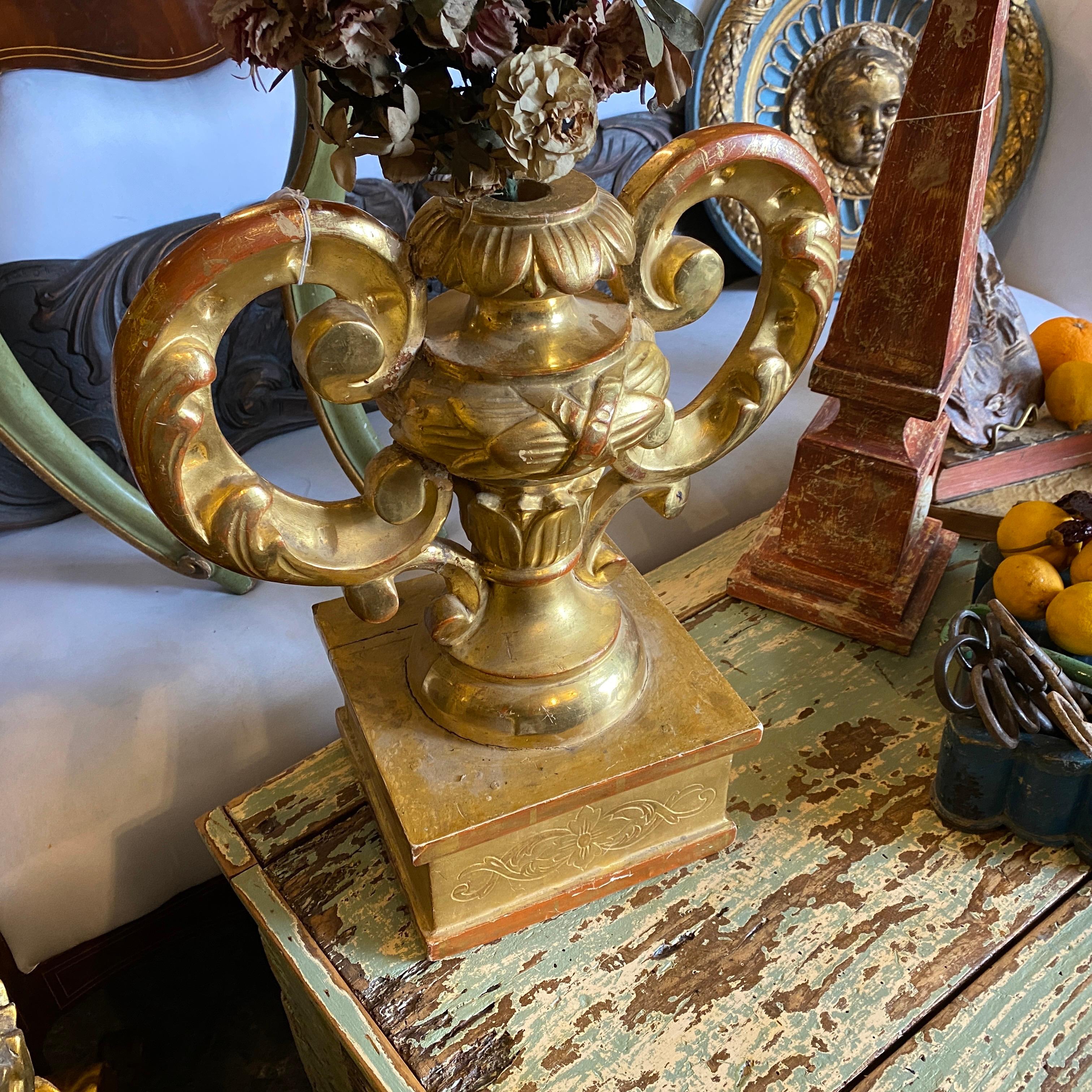 A 19th century antique gilded wood torchere on a base, also the floral arrangement is an original one. It's in good conditions considering age and use.