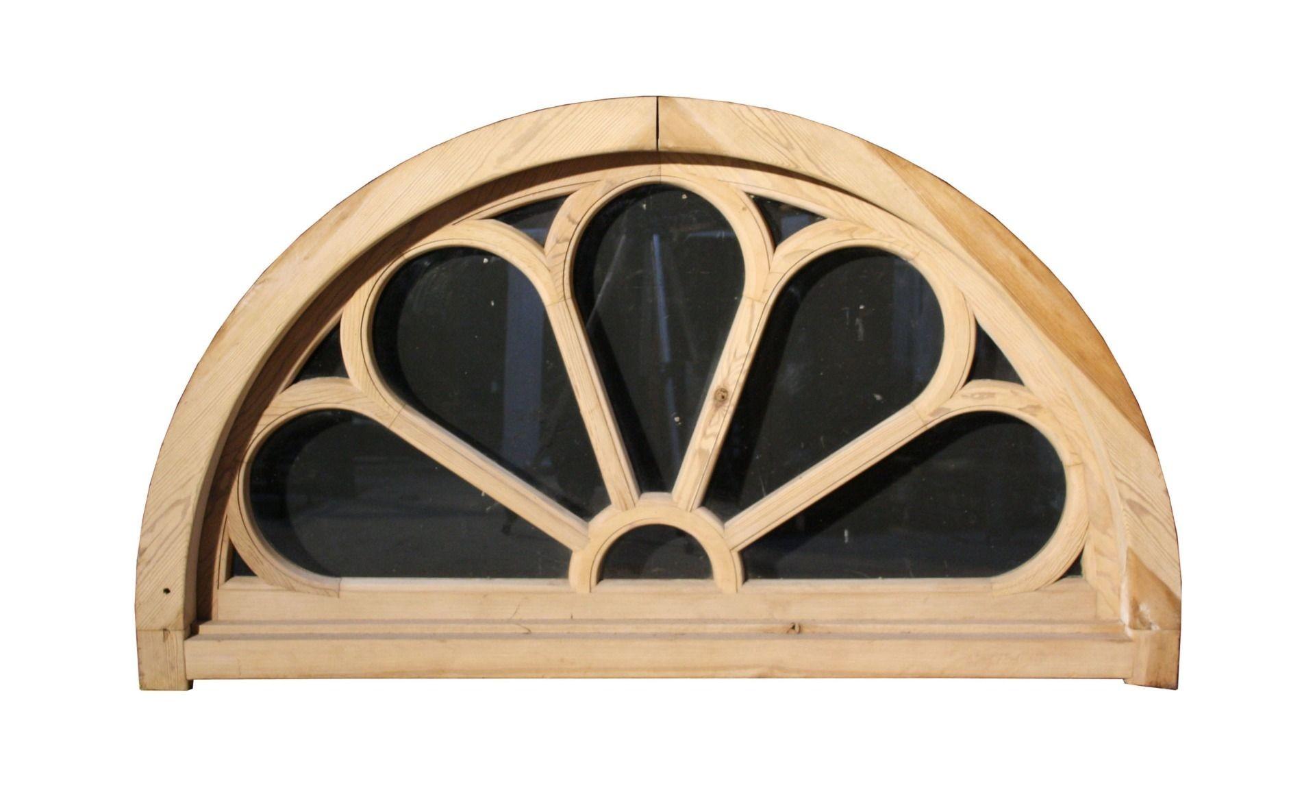 An antique fanlight constructed from pine. Glazed with clear glass and fitted within its original frame.