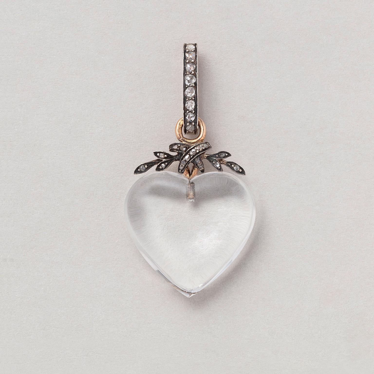 A heart-shaped rock crystal pendant with an 18-carat gold and silver laurel motif along the top of the heart and a large bail all set with rose cut diamonds (app. 0.31 carat). France, 19th century.

weight: 7.19 grams
dimensions: 4 x 2 cm
