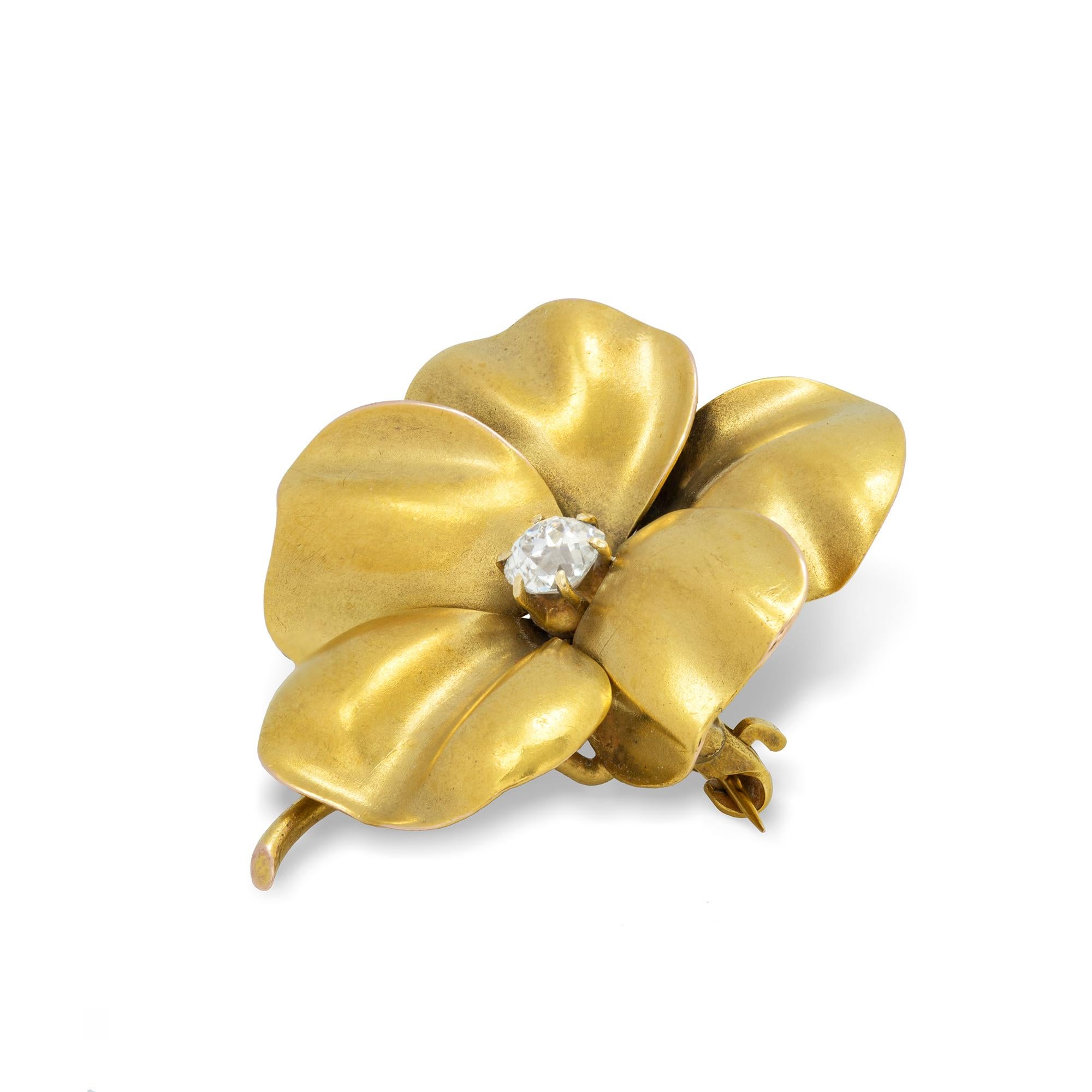 An antique gold pansy brooch, a round old-cut diamond weighing approximately 0.25 carats, to the centre of five realistically carved petals, all made in yellow gold with brooch fittings, stamped 18K, made in the USA, circa 1900, overall dimension