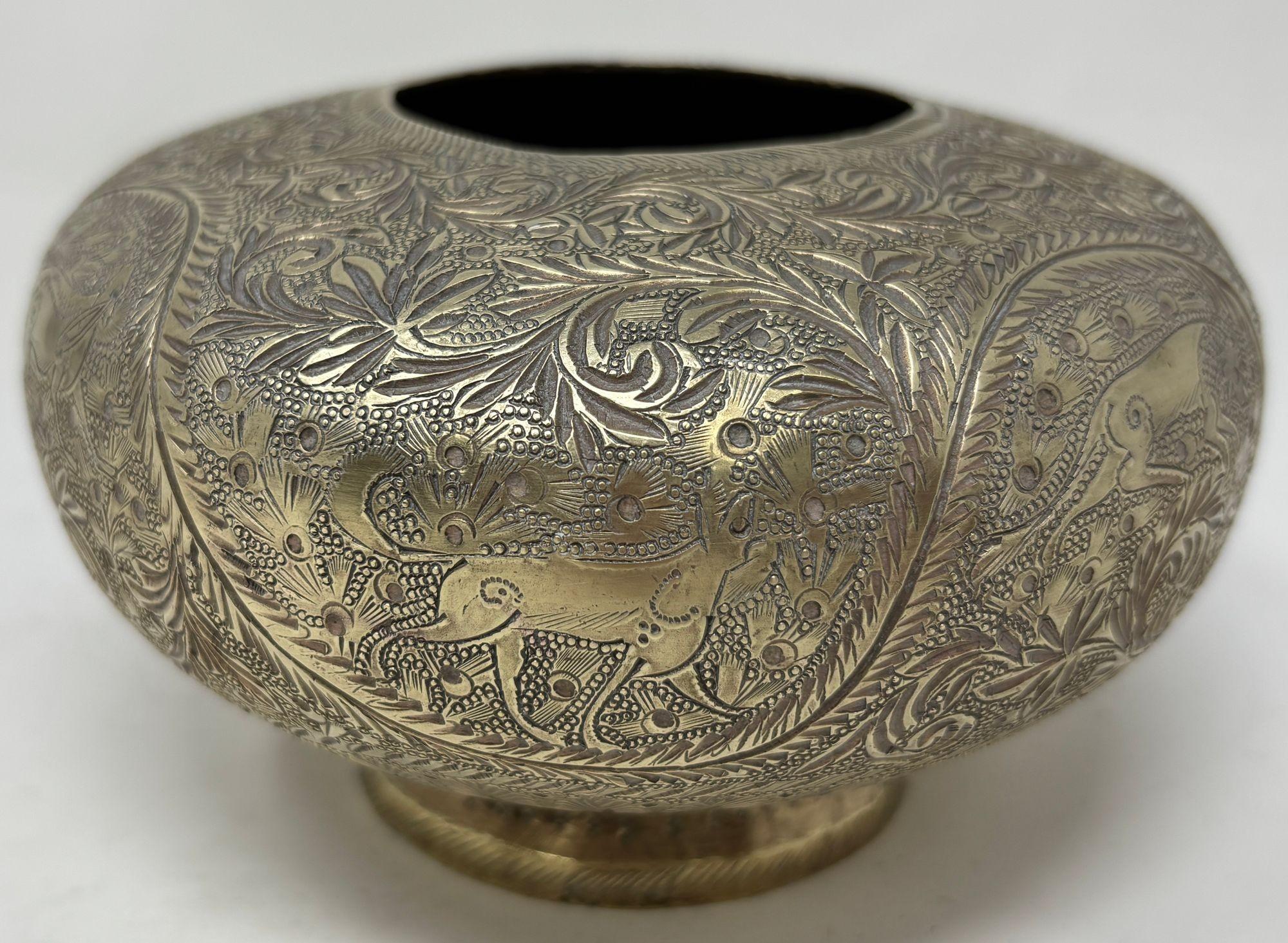 An antique Hand-Chiseled Indo-Persian Brass Bowl.
An exquisite antique Indo-Persian brass bowl, masterfully hand-chiseled with intricate arabesque, floral, and animal motifs.
Crafted in the Qajar or possibly late Safavid tradition, this small footed