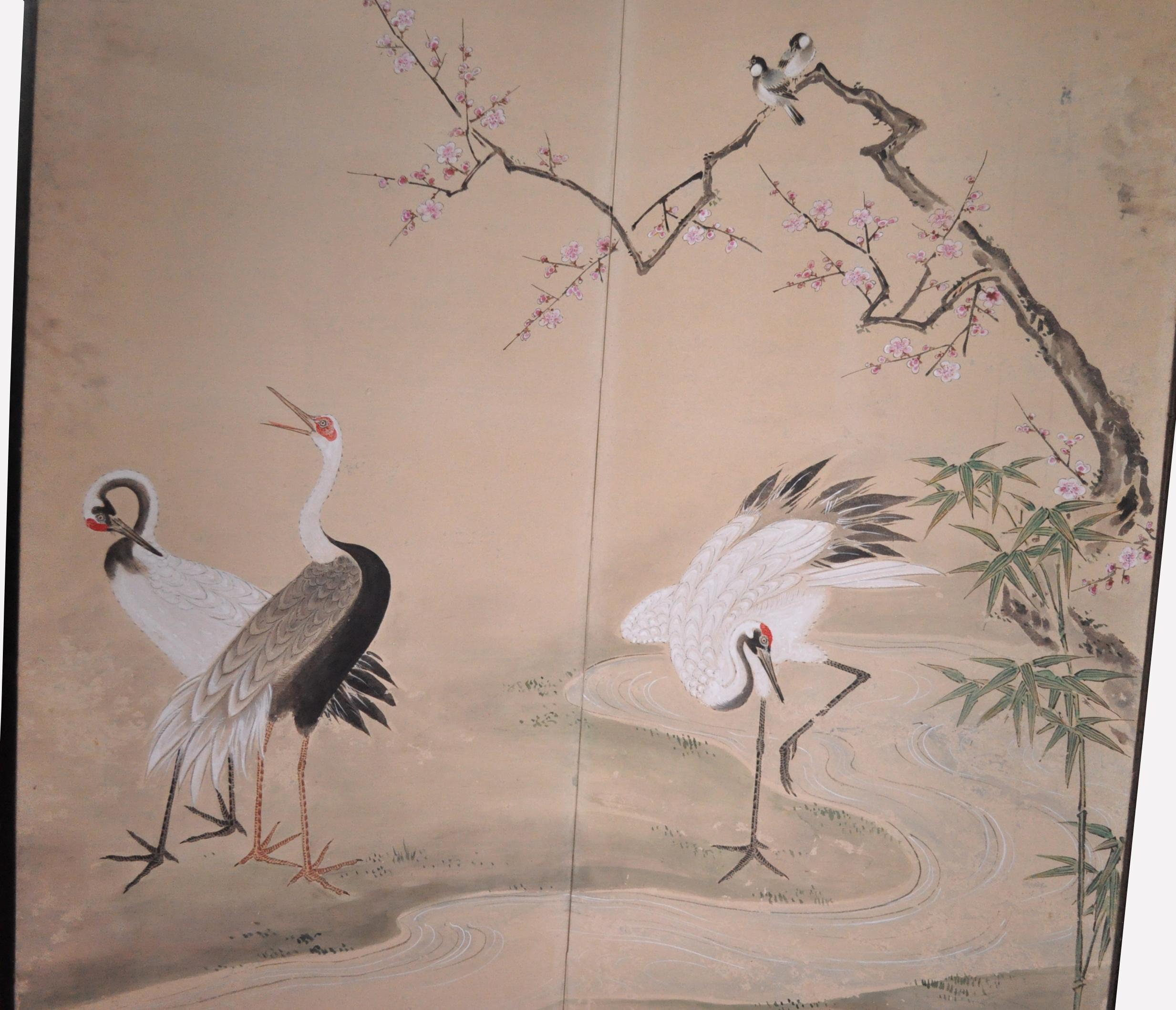 
An elegant antique Japanese 6-panel (byobu) screen painted with a composition of five standing cranes by a rushing stream surrounded by plum blossoms and bamboo with mountains in the distance. These elements are classic in their auspicious intent,