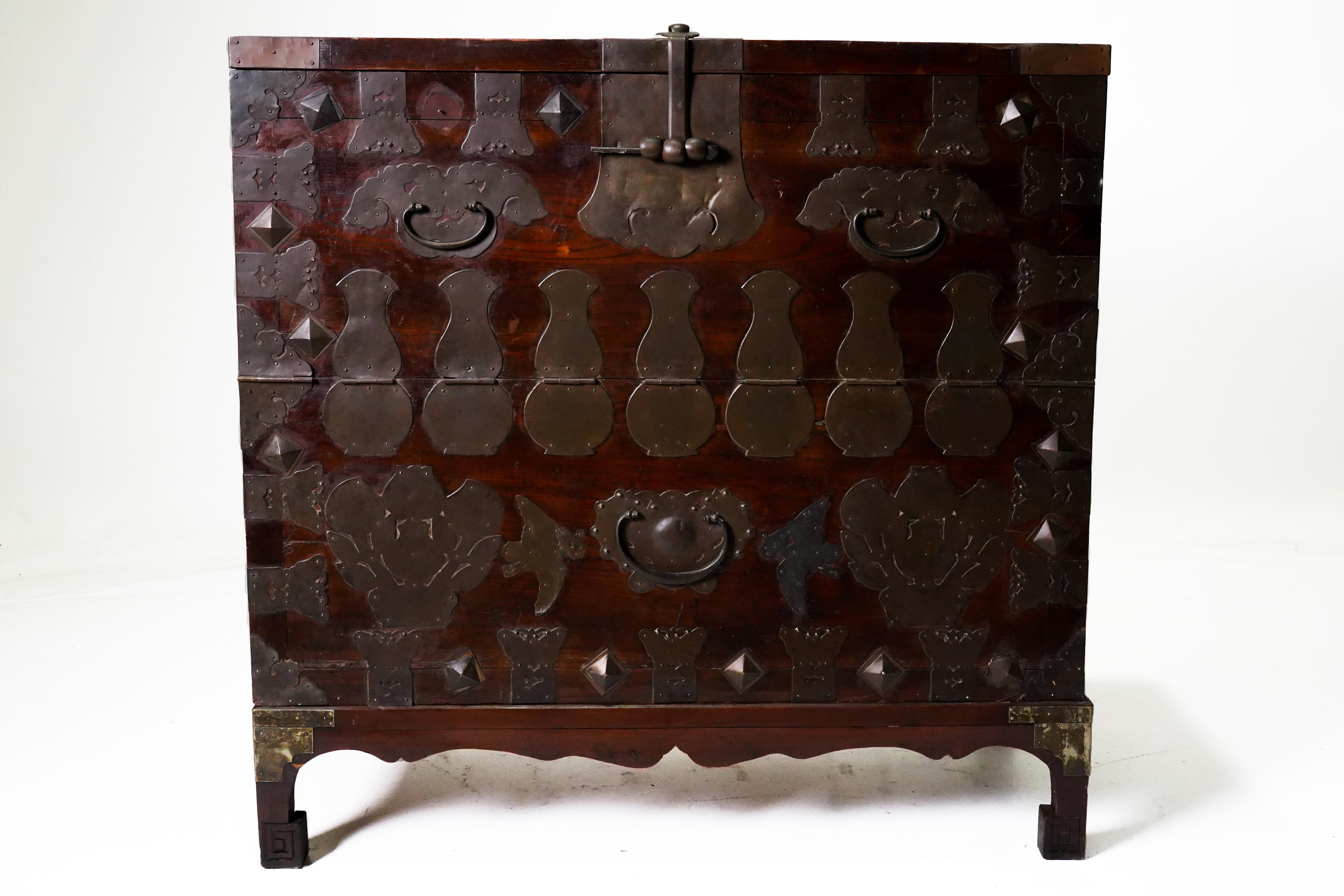 This beautifully ornamented Korean chest once held blankets, clothing and valuables and may have been given as part of a marriage dowry.  The elaborate brass hardware is made from a zinc-rich copper alloy and has been engraved with auspicious