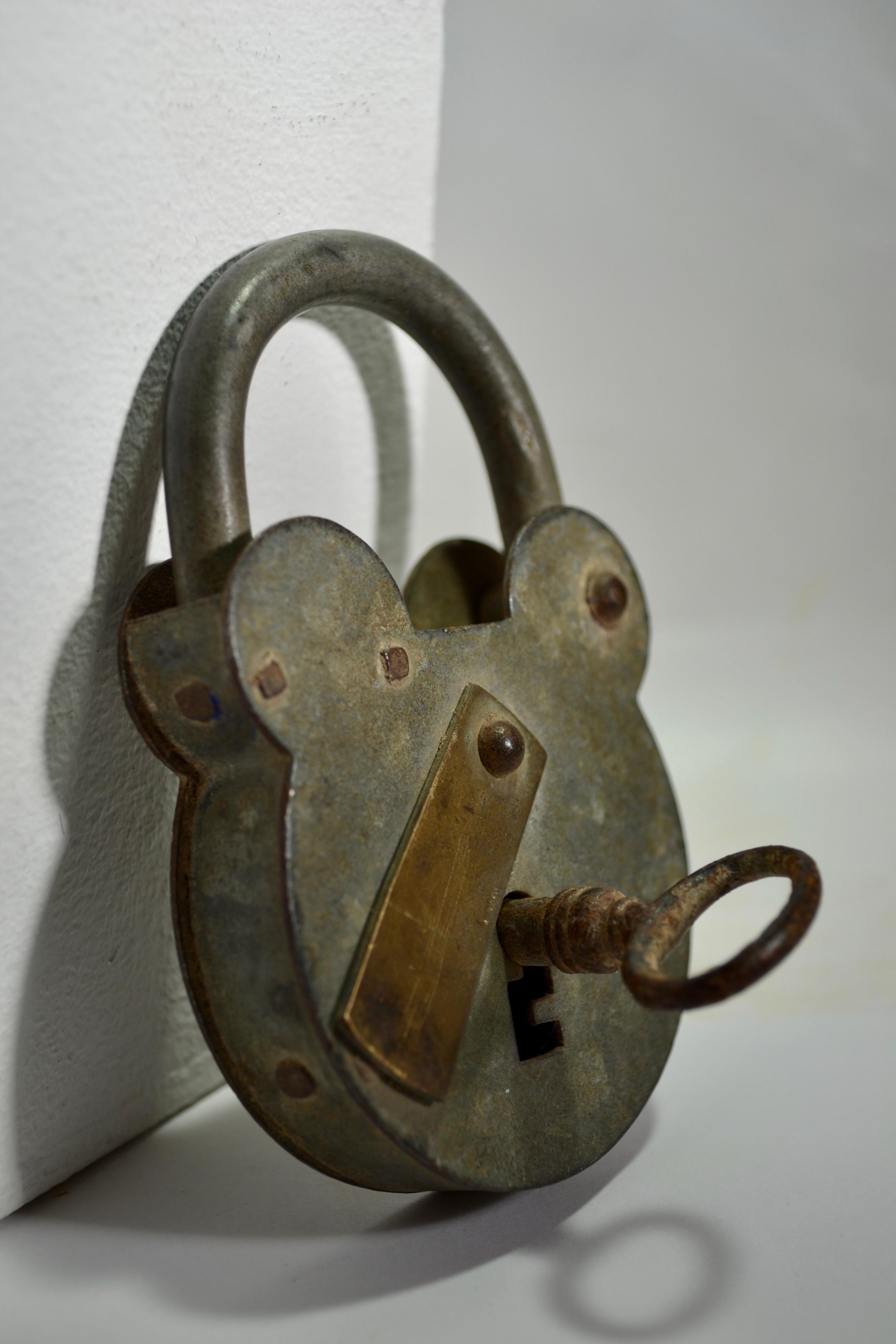 Antique large padlock accompanied by its original functional skeleton key.






