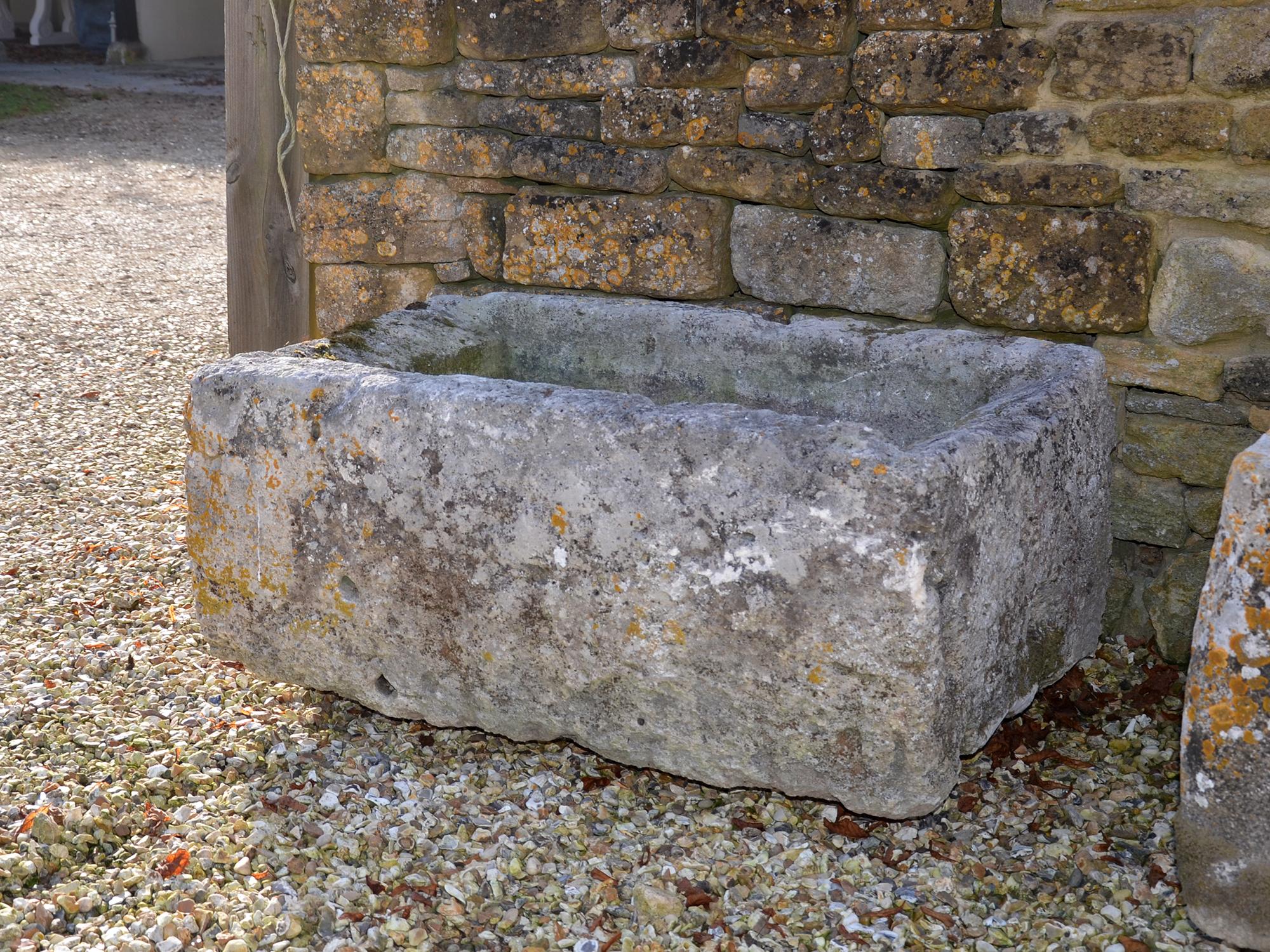 Antique limestone trough with good weathering and patination.
