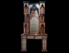 An antique Moorish revival style walnut fireplace with inlays.