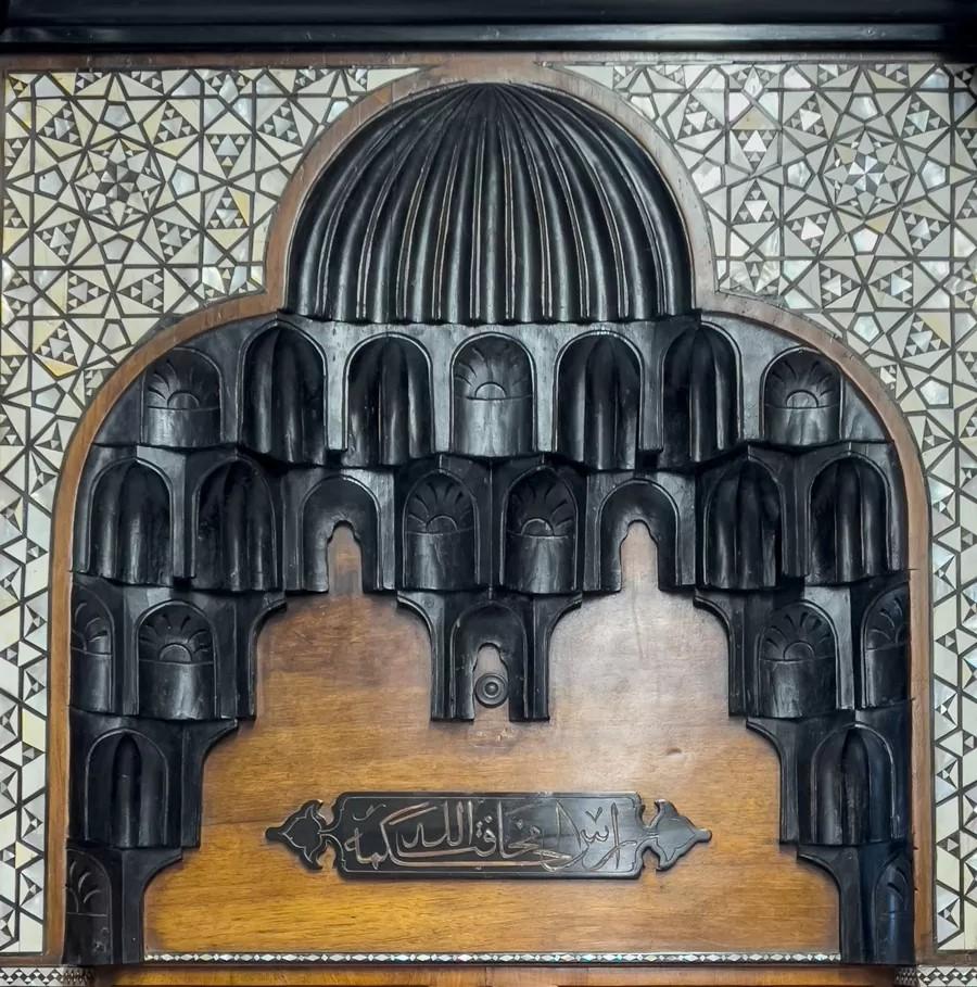 Late 19th Century An antique Moorish revival style walnut fireplace with inlays. For Sale