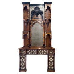 An antique Moorish revival style walnut fireplace with inlays.