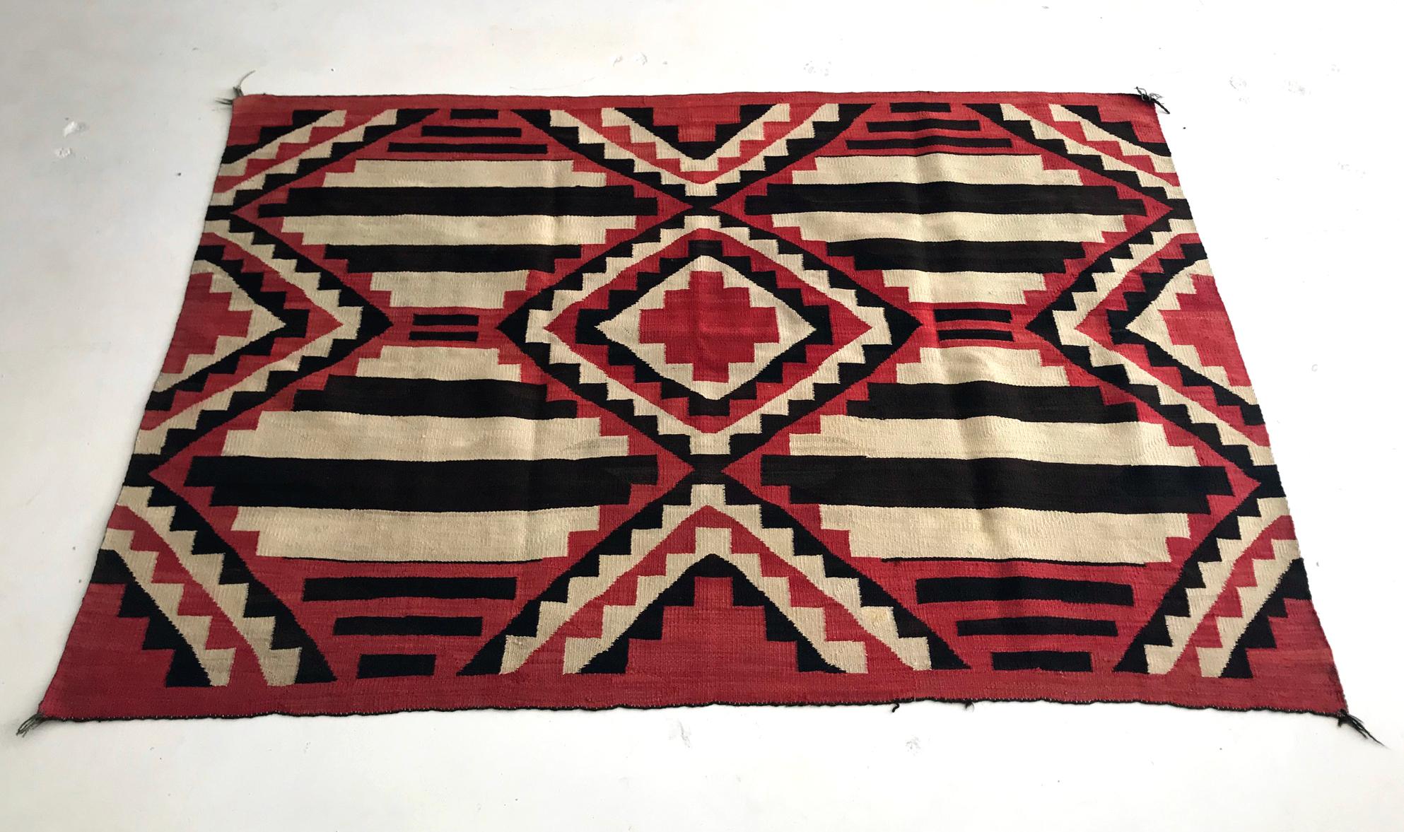 Sometimes categorized as the fourth-phase chief blanket, this wonderful piece of Navajo textile art is well preserved and can be dated to 1890-1910. Woven with hand-spun natural yarns in white and black, and possibly unraveled bayeta yarns, this