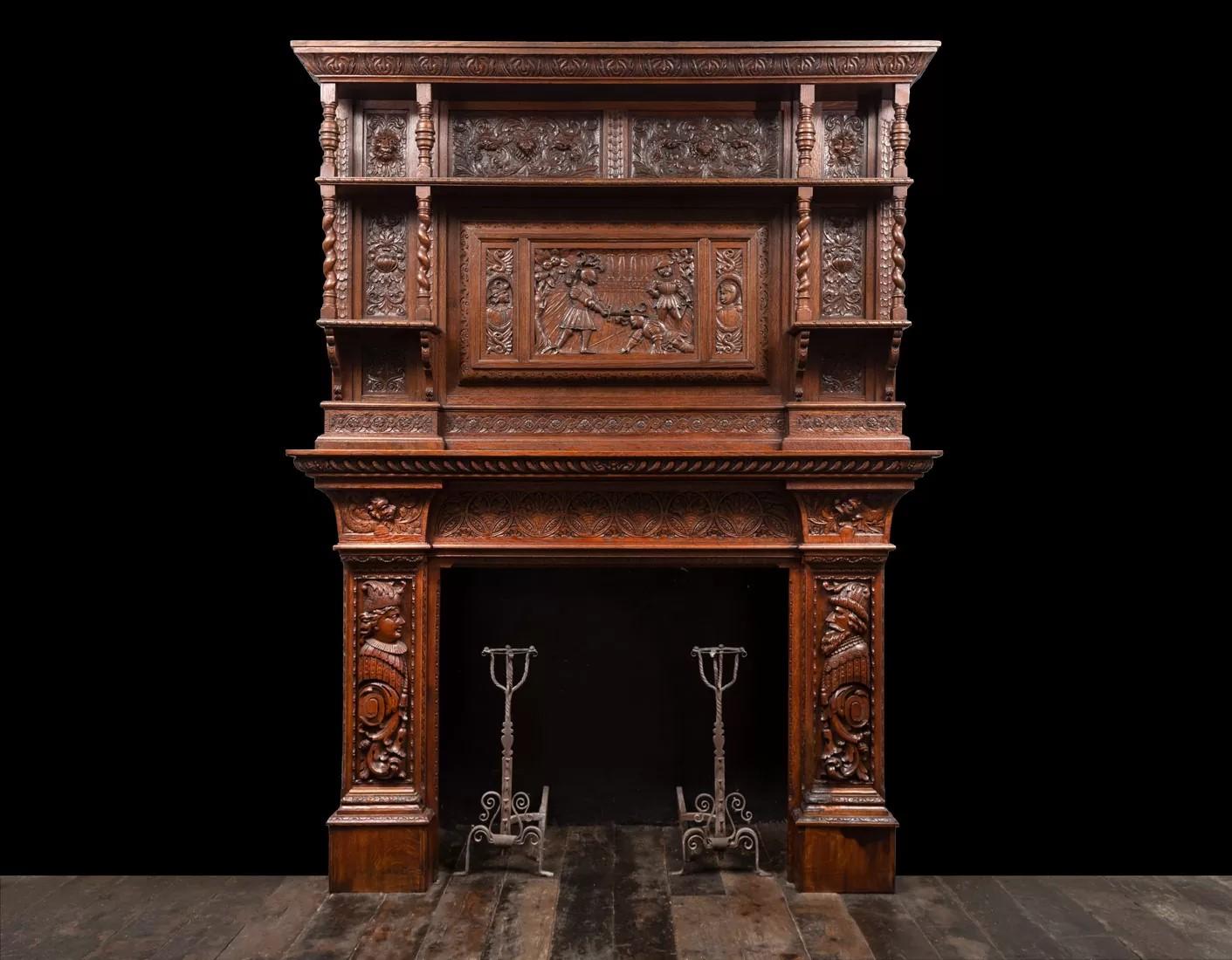 A large and highly carved antique oak fireplace surround, made in the Jacobean style.
Produced in England during the 19th century incorporating 17th century and 18th century carved elements.