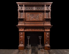 An antique oak fireplace surround, made in the Jacobean style.