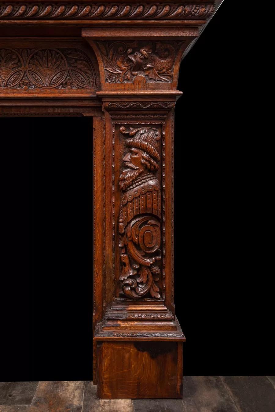 English An antique oak fireplace surround, made in the Jacobean style. For Sale