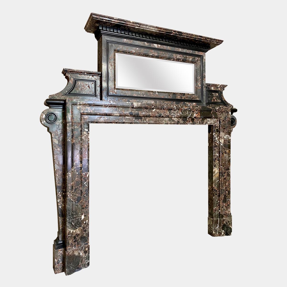 A rare and unusual Palladian style 19th century fireplace in Marrone Breccia and Belgian black marbles, with a marble mirrored overmantel. The top pediment with dental work carving in Belgian black marble, surmounts the beveled original mercury