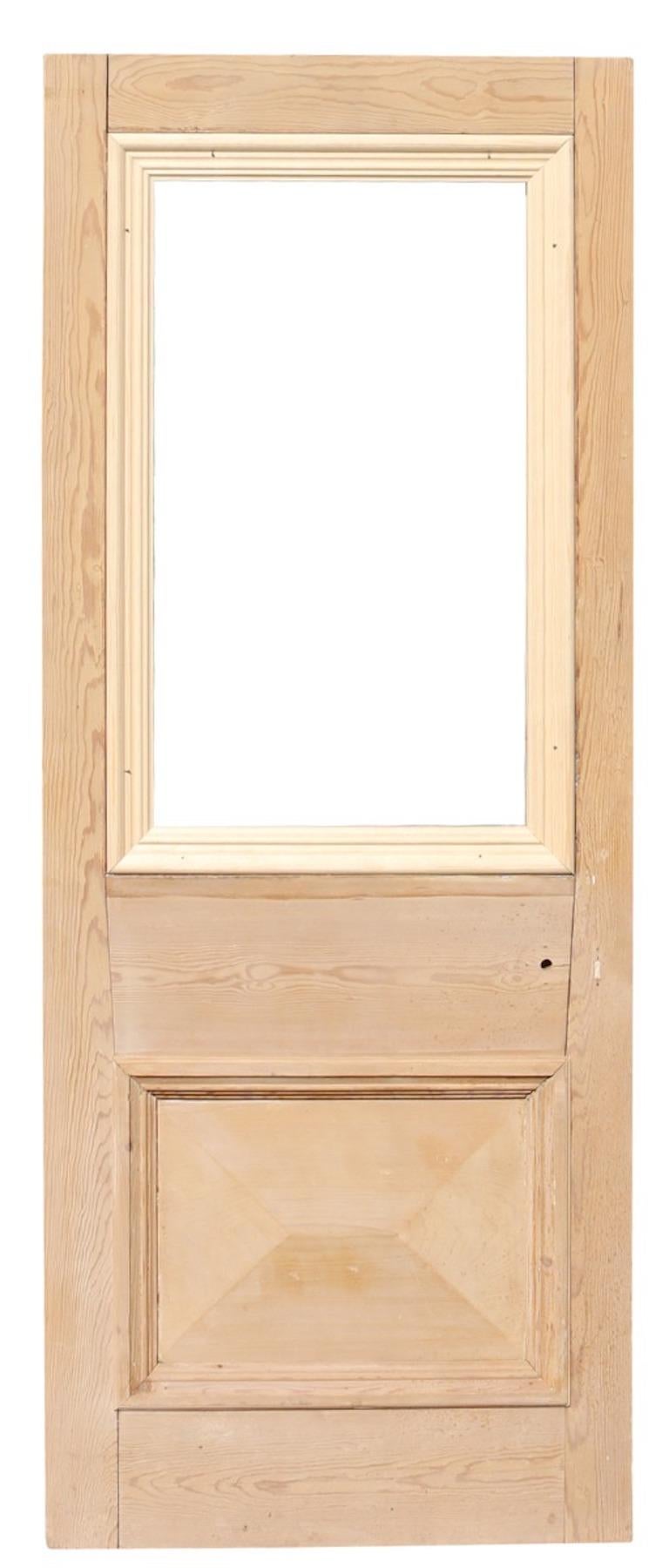 A reclaimed door suitable for interior or exterior use, constructed from pine, with space for a single glazed panel.