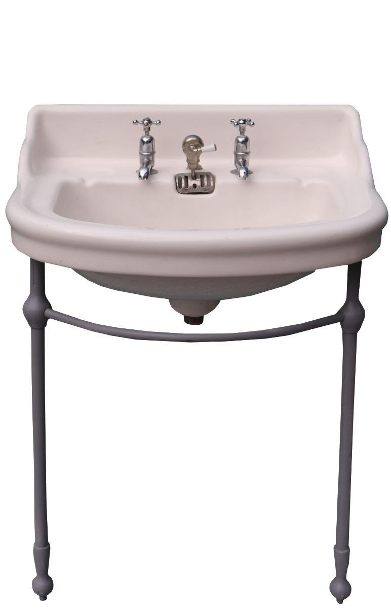 A good quality antique basin with a floor standing iron bracket, finished in grey primer. 
There are minor scuffs and marks to the porcelain. No cracks or breaks. In good condition overall condition.
Wear consistent with age and use. Minor Losses,